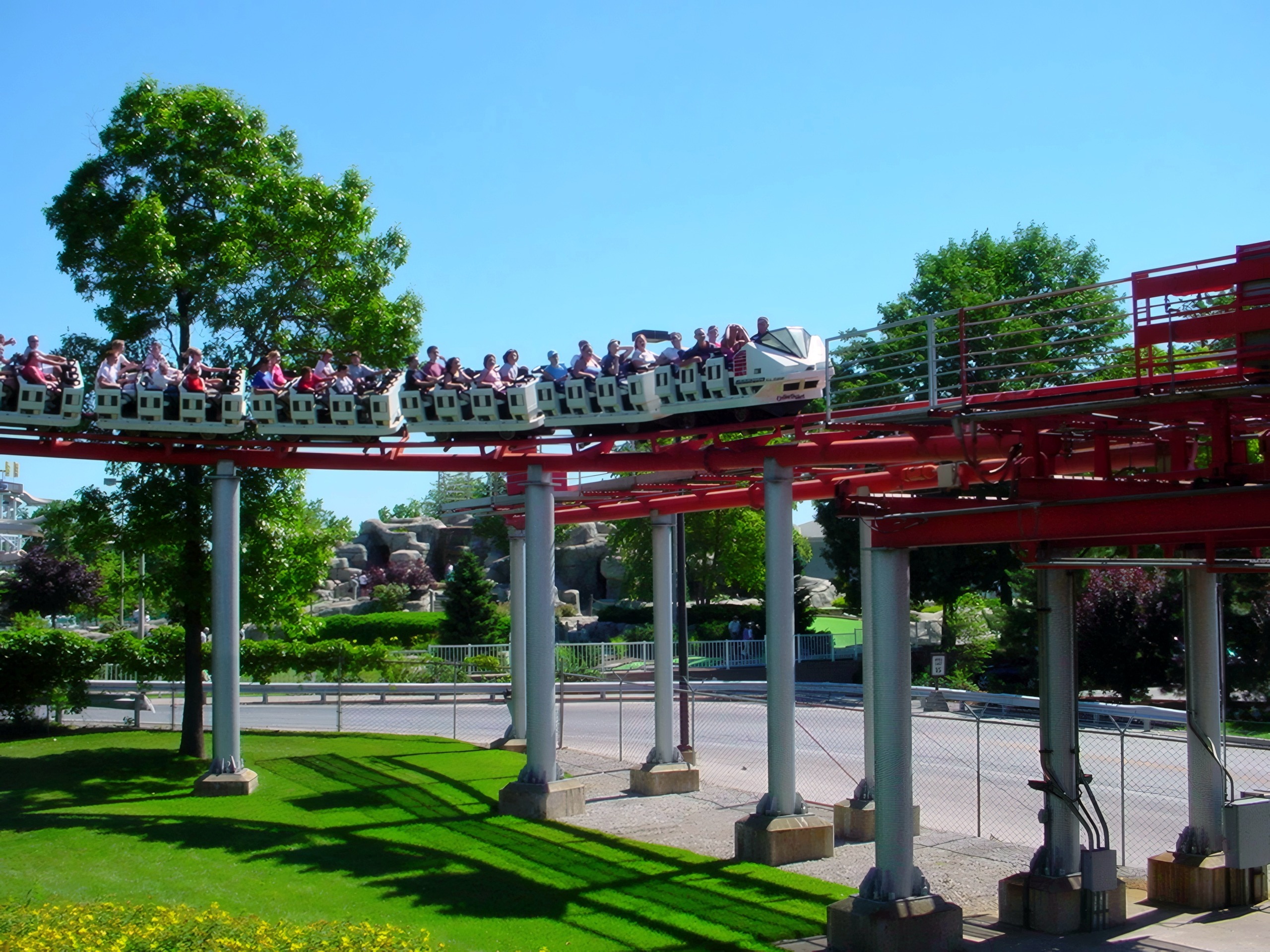 Suspended coaster train with riders on red track, Magnum XL-200, July 2003