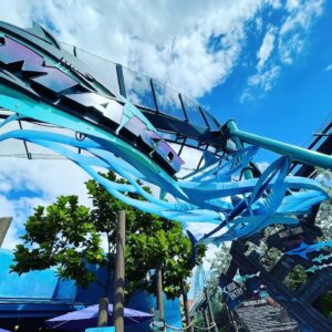 Mako's blue shark sculptures and wave decoration under the track and station canopy, SeaWorld Orlando, March 2021