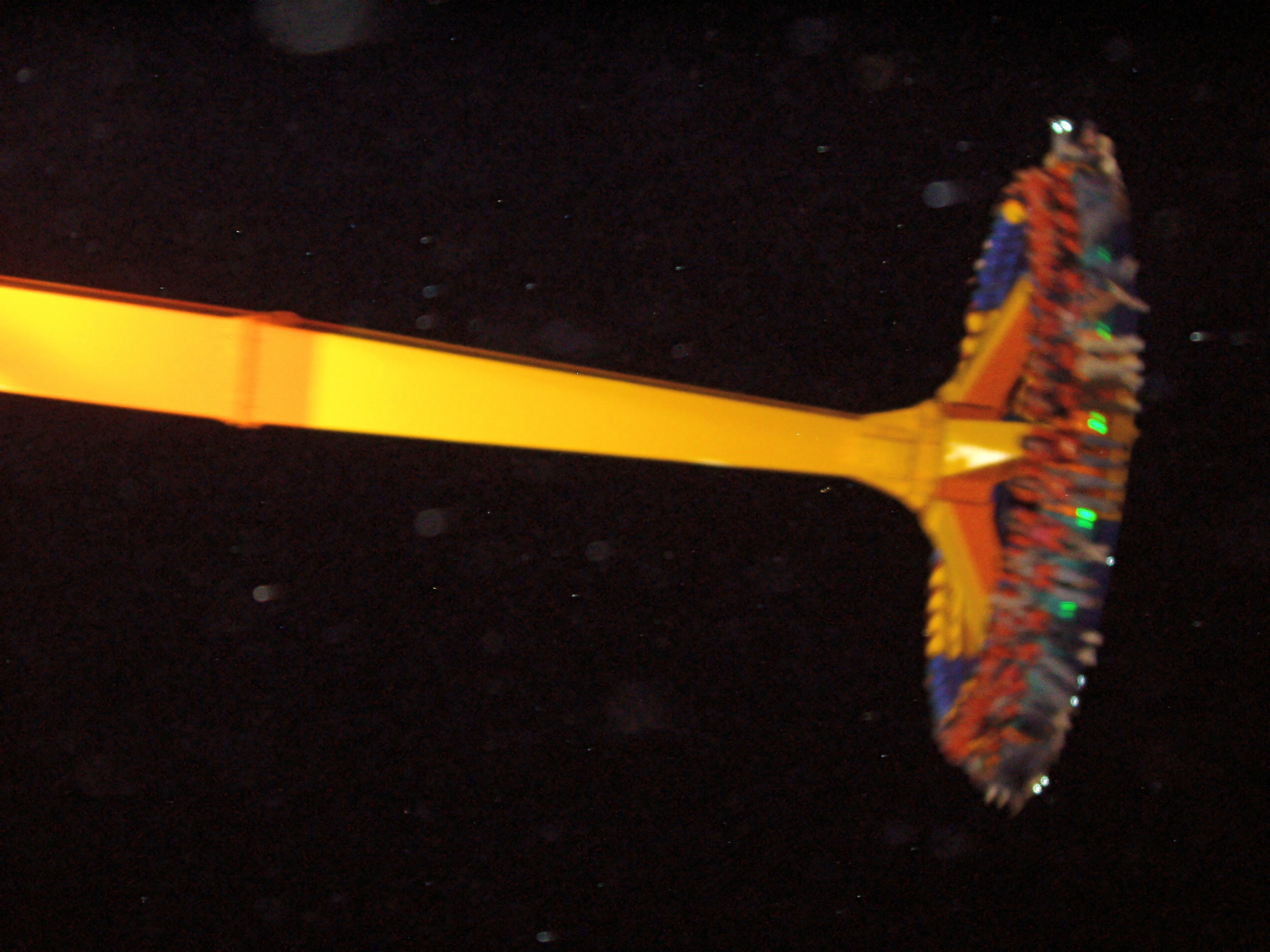 maXair's yellow arm swinging its disc of riders against the night sky at Cedar Point, May 2005