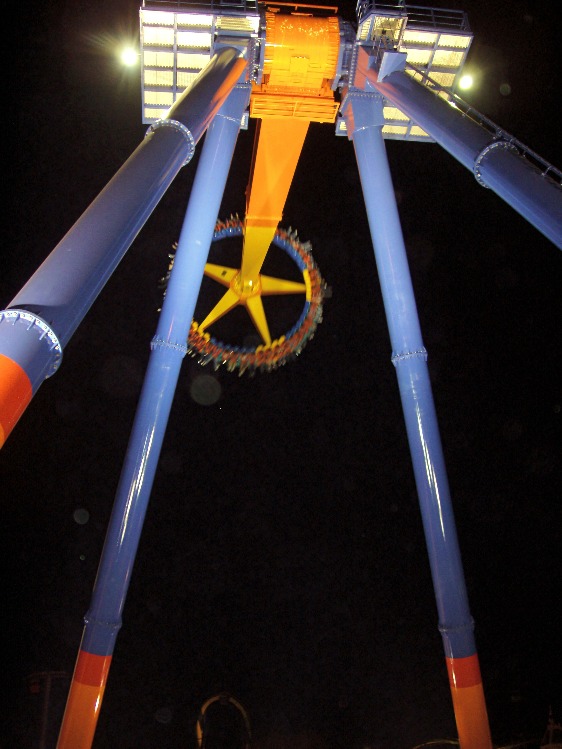 maXair's spinning ring of riders beneath its blue towers at night at Cedar Point, May 2005