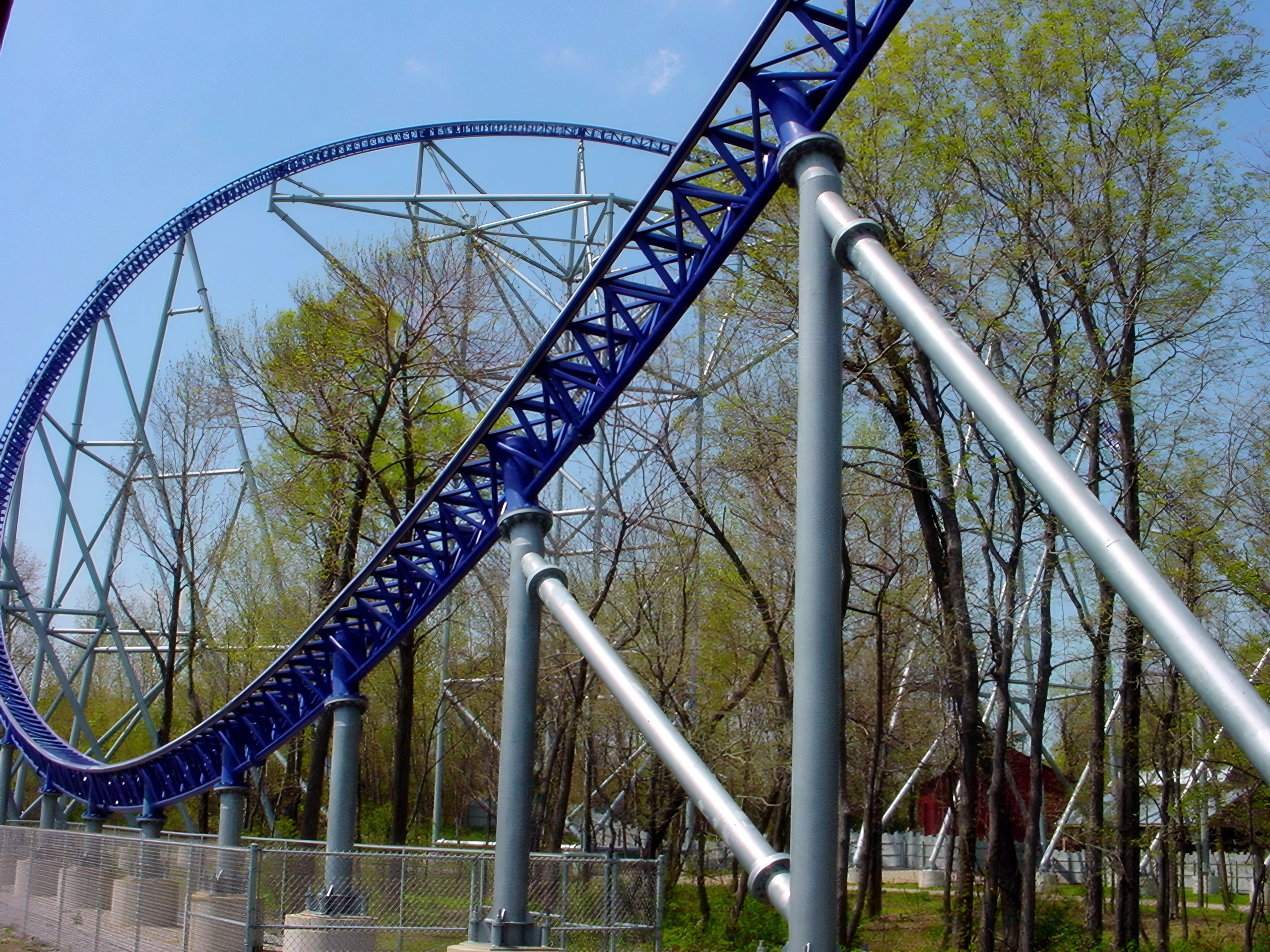 Blue inverted coaster loop rising above spring trees, Millennium Force, May 2002