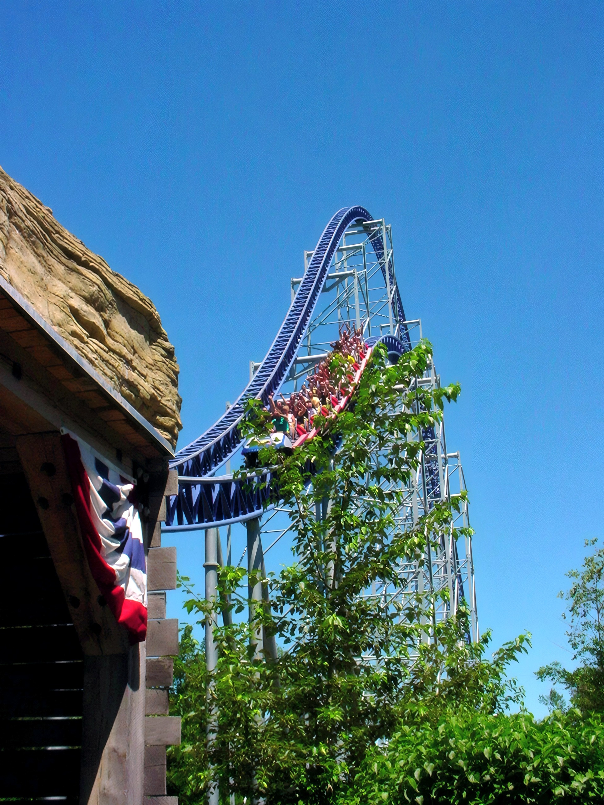 Coaster track with patriotic bunting climbing past rock outcrop, Millennium Force, July 2003