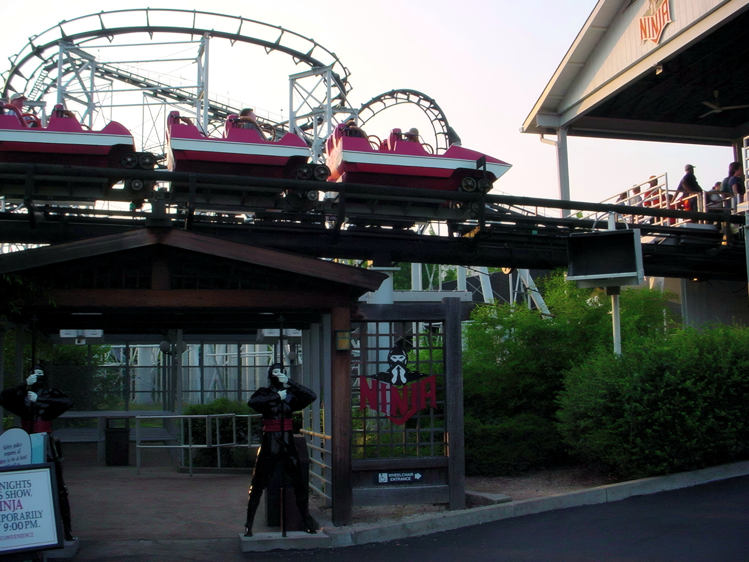 A red Ninja train leaving the station above the entrance at Mid America Adventure, June 2002