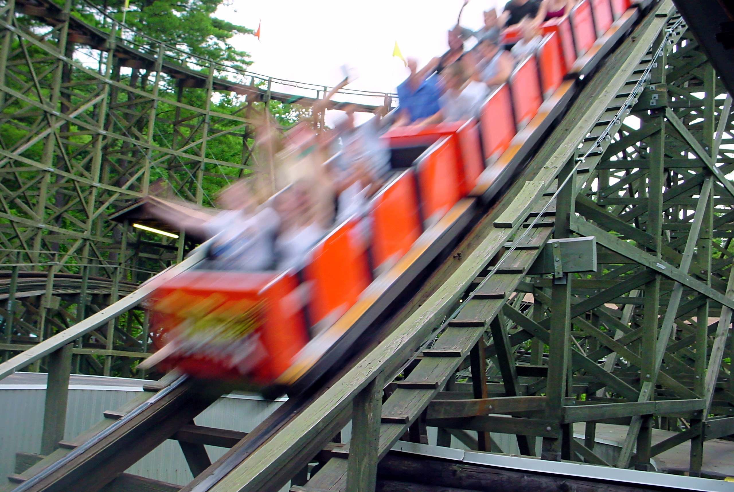 Phoenix riders with their hands up descending a hill, July 2003