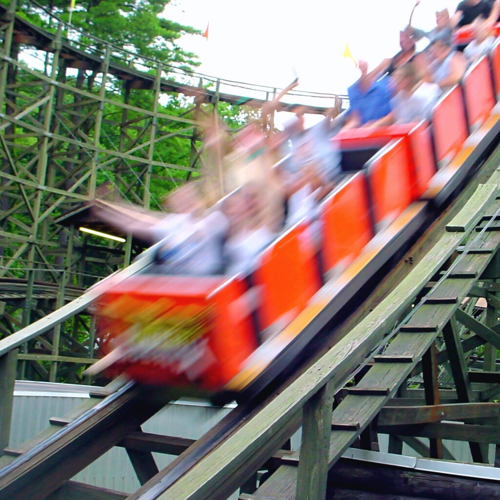 Phoenix riders with their hands up on a drop at Knoebels, July 2003