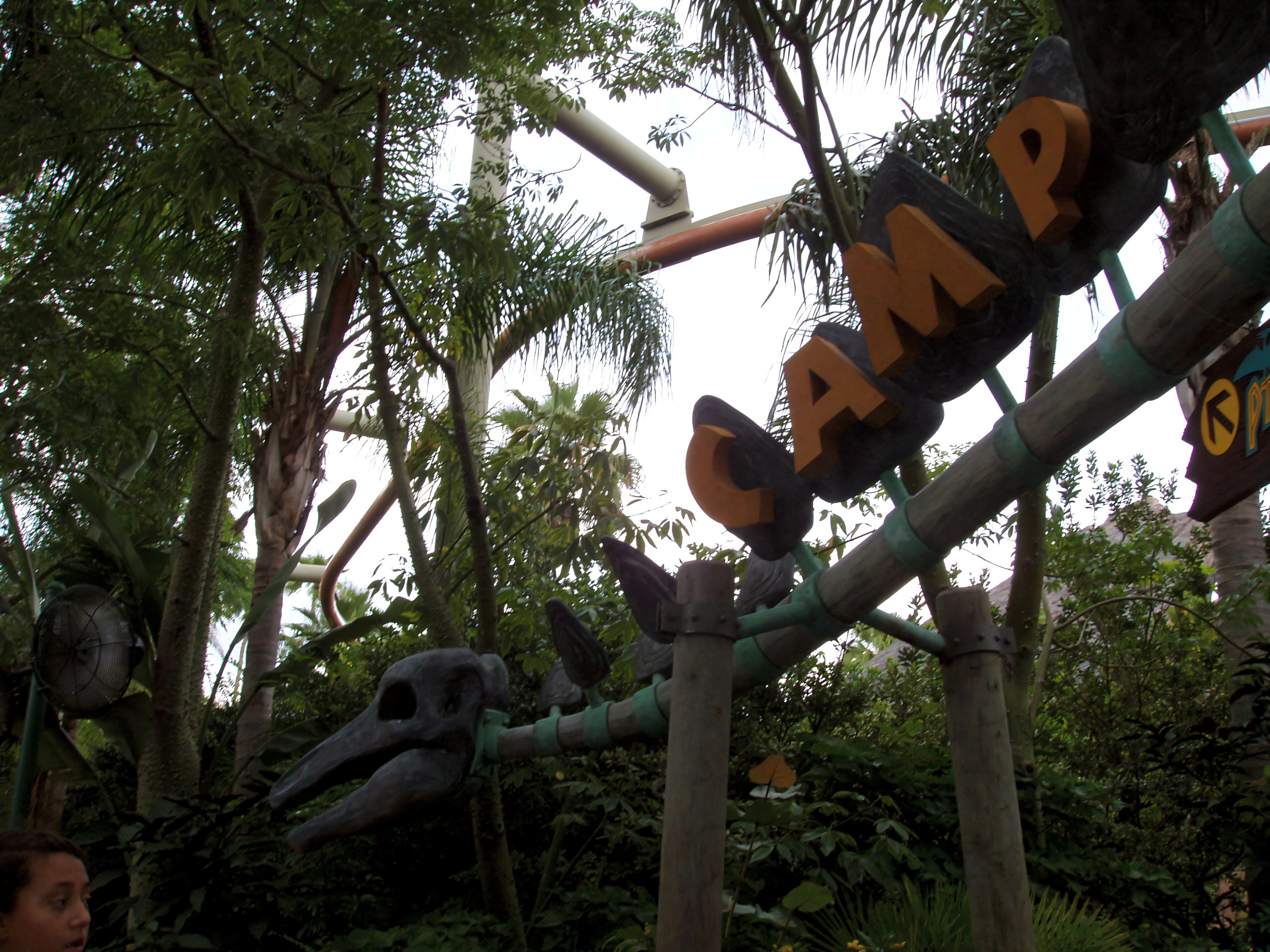 The Camp Jurassic sign with a dinosaur skull beneath Pteranodon Flyers' track at Universal's Islands of Adventure, July 2006