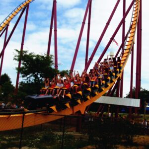 A Raging Bull train full of riders with their hands up sweeping through the valley at Six Flags Great America