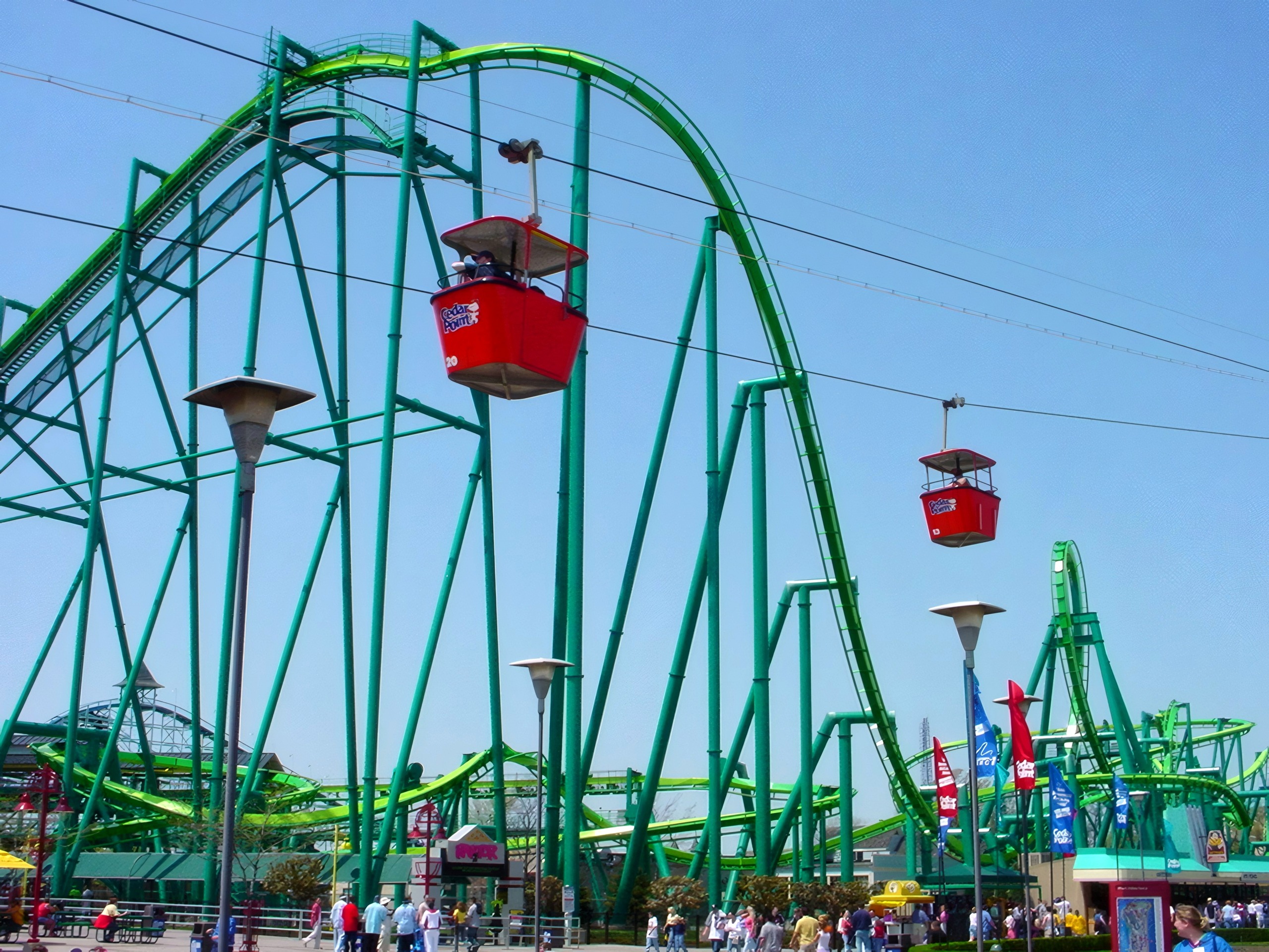 Green coaster hills with red Sky Ride gondolas overhead, Raptor, May 2002