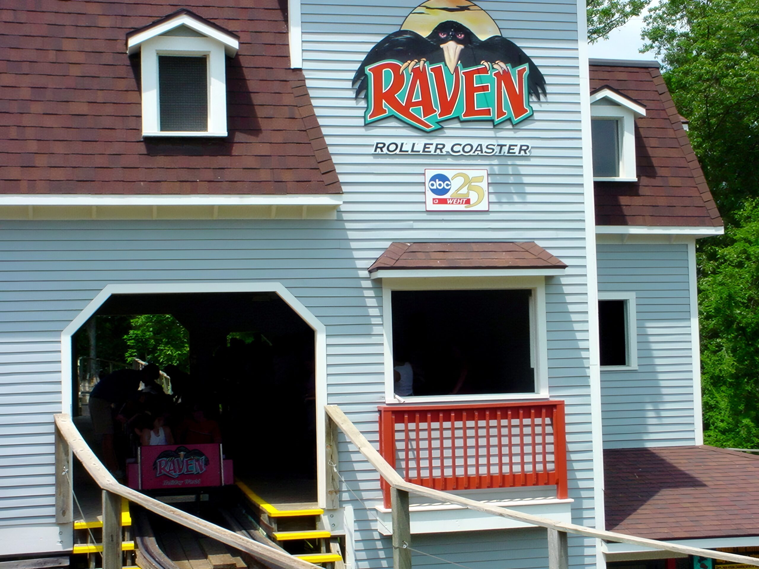 The Raven's Victorian-style station house with the ride logo, July 2002