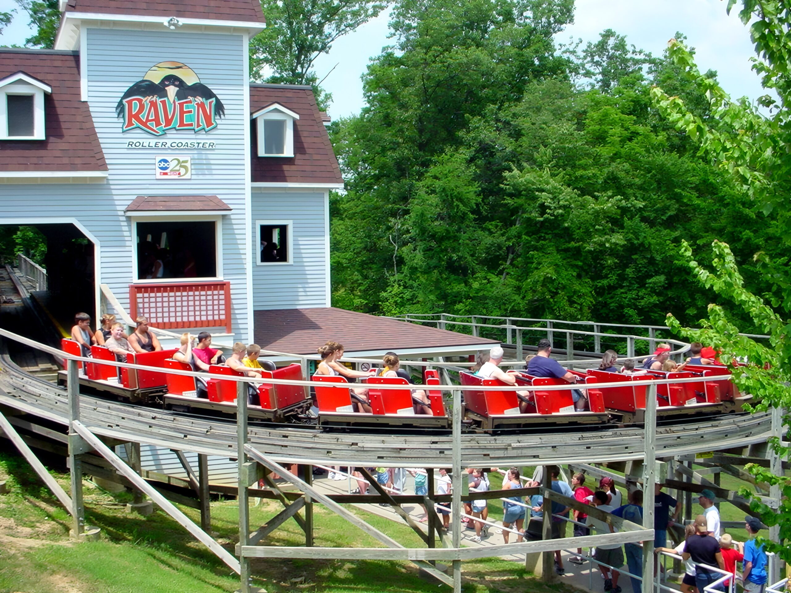 A Raven train full of riders passing the station, July 2002