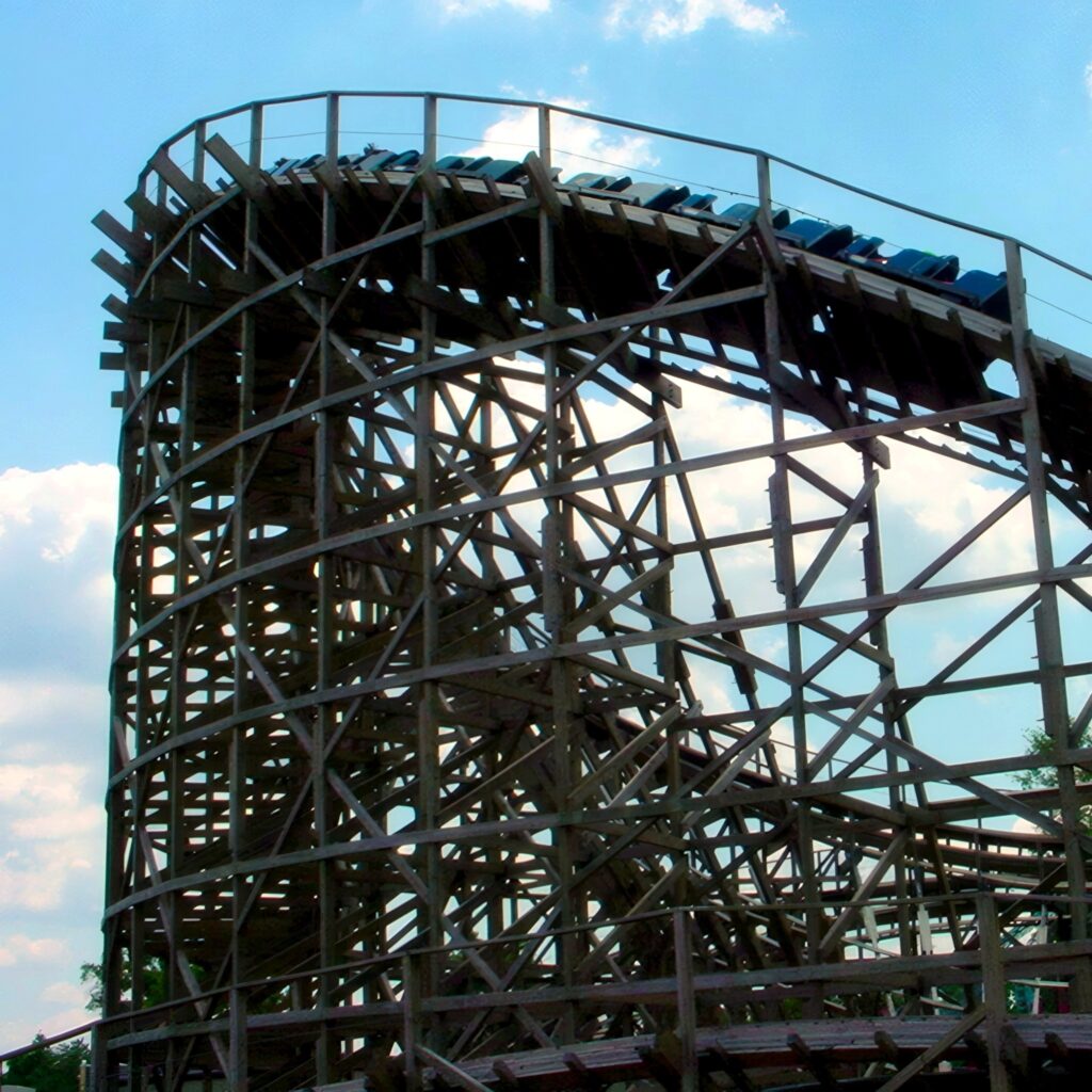 Roar at Six Flags America: a train on the wooden structure against the clouds