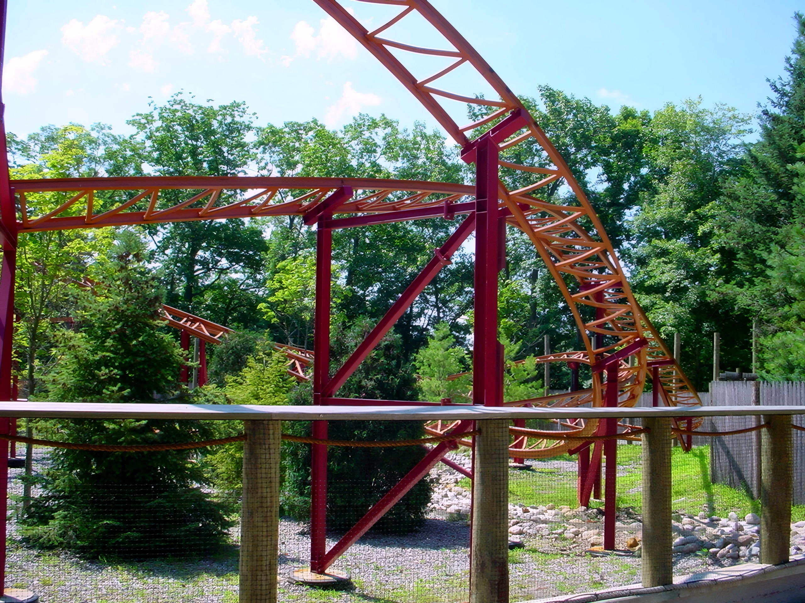 Red steel coaster support structure and track amid trees, Sarajevo Bobsled, July 2001