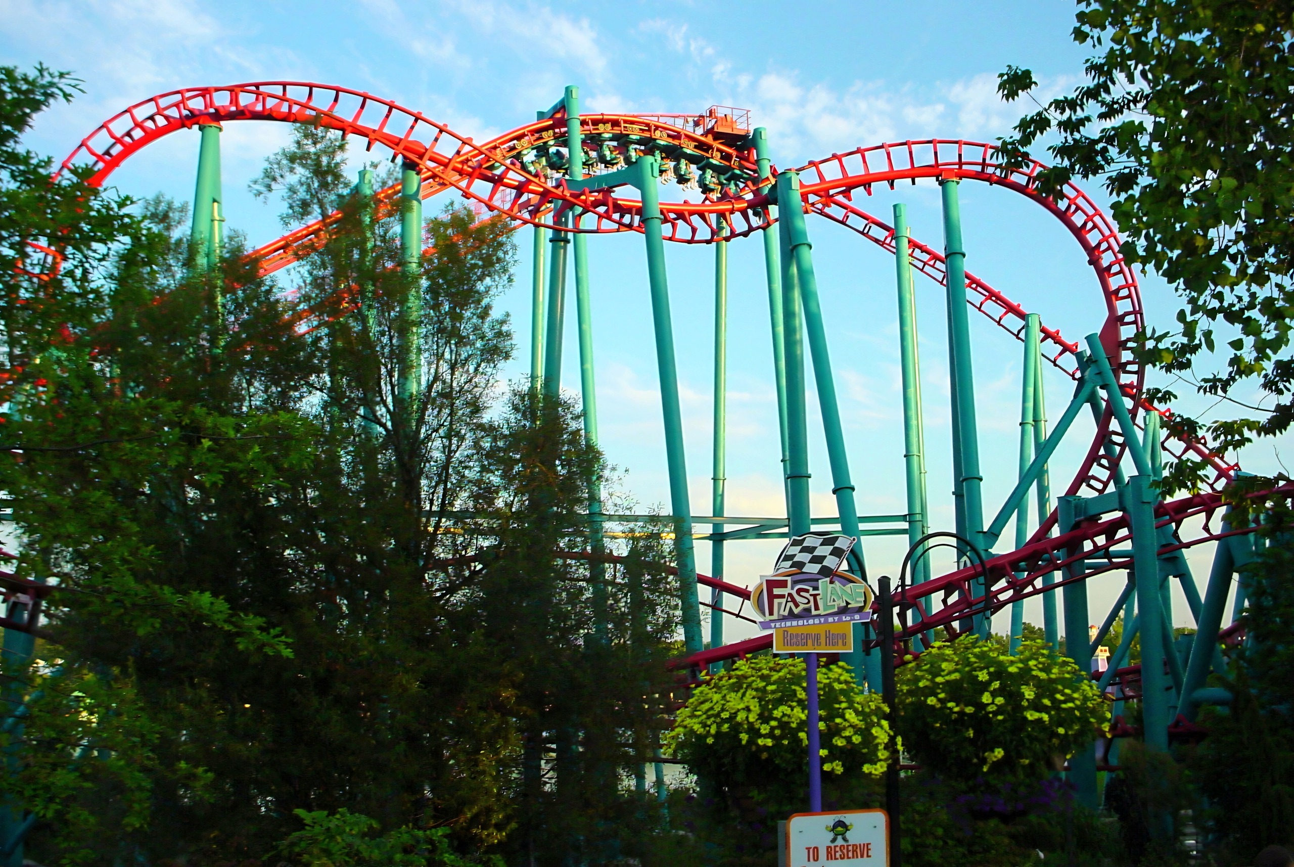 Tangled red and teal steel coaster track against sky, Serial Thriller, July 2003