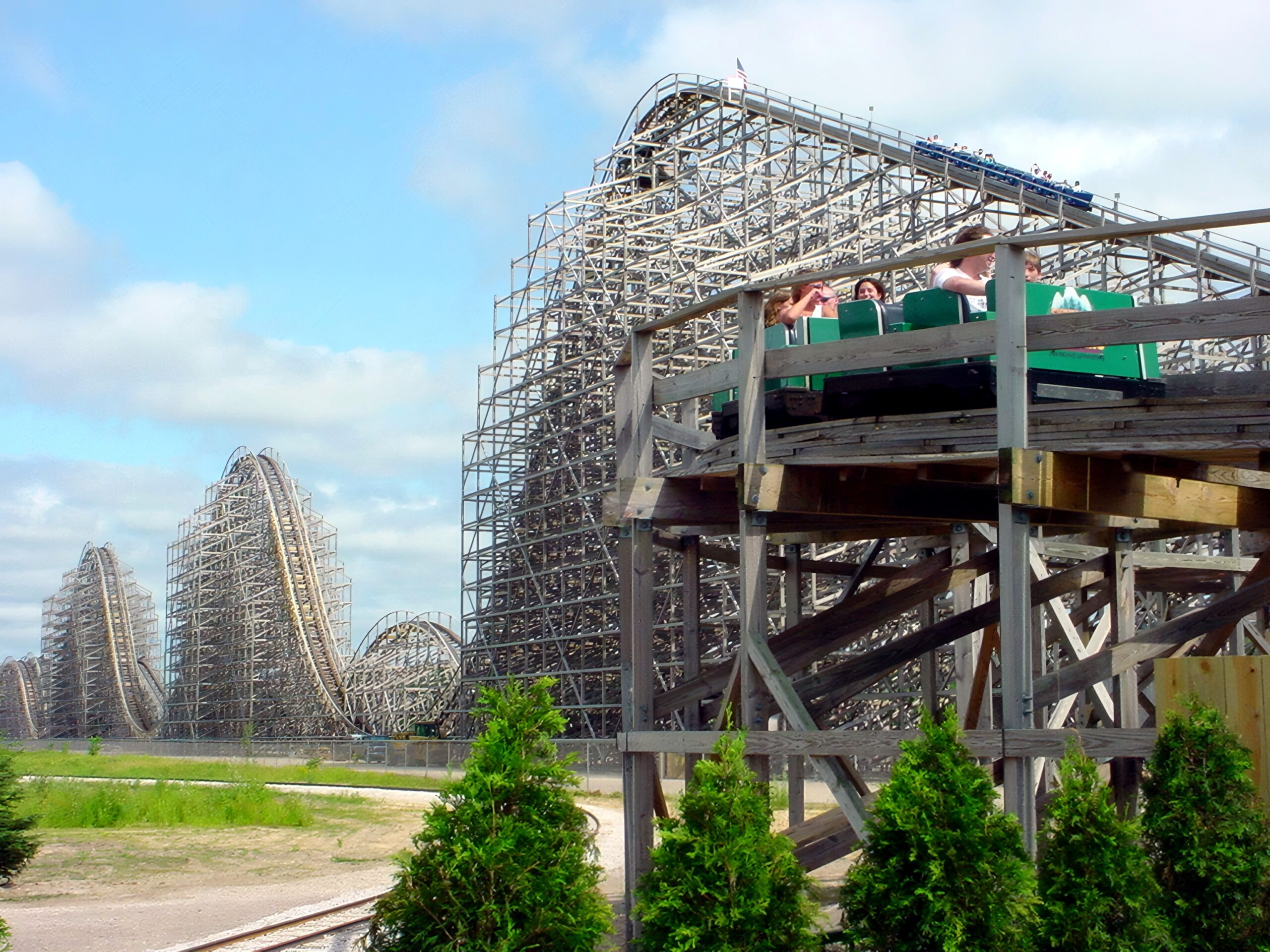 Riders on a Shivering Timbers train passing close to the camera, June 2002