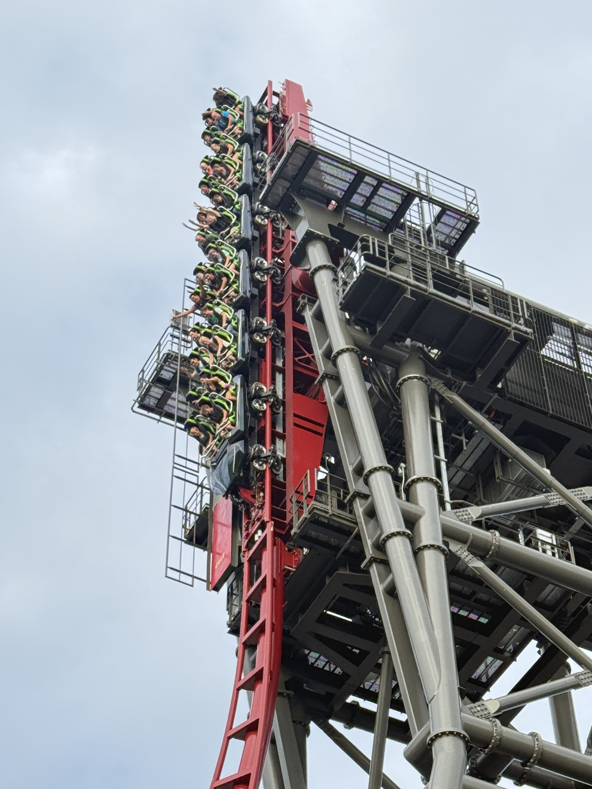 A close-up of the Siren's Curse tilt section with the train hanging vertical
