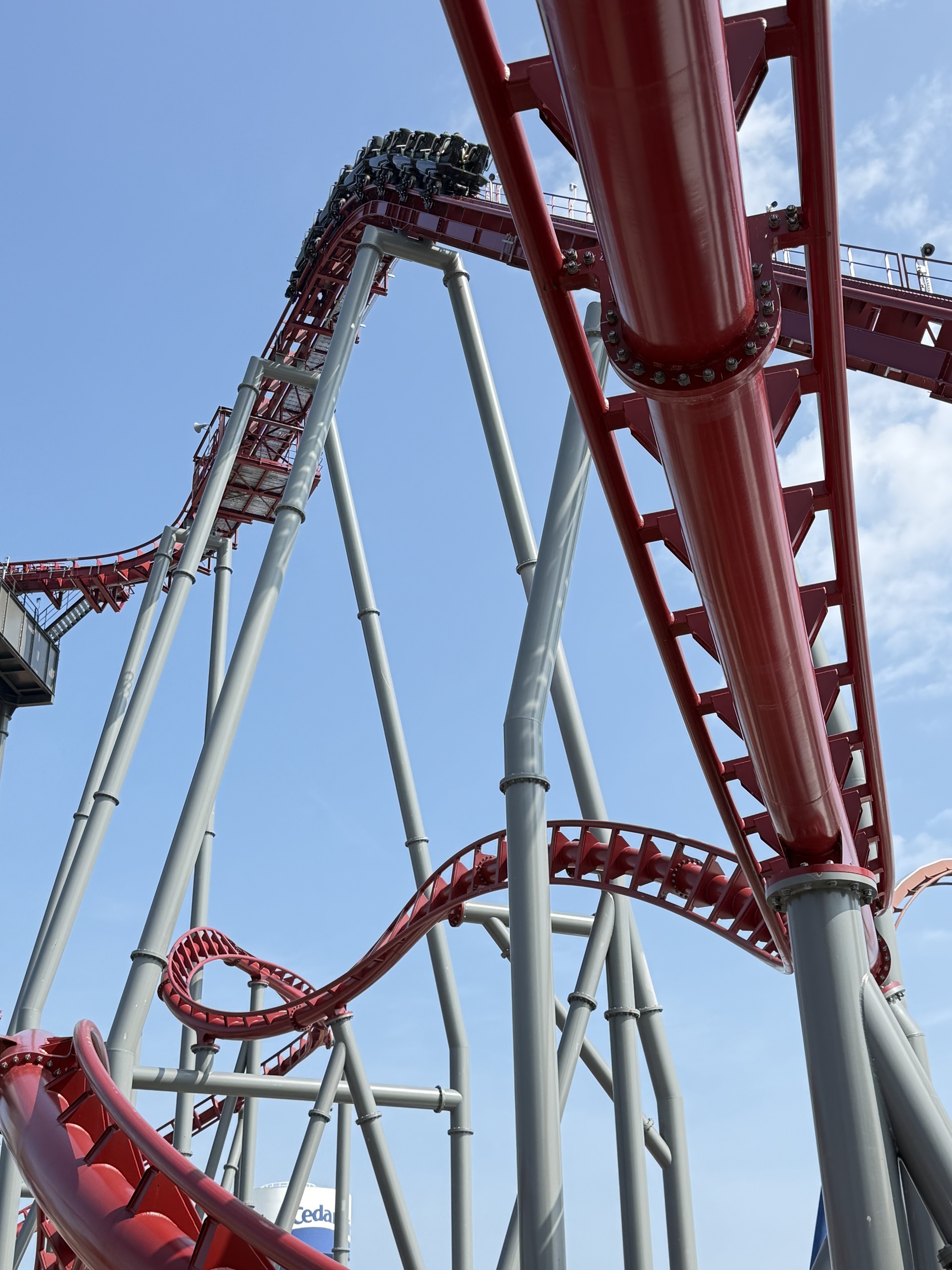 Siren's Curse's red track and tilt section with a train, seen from below