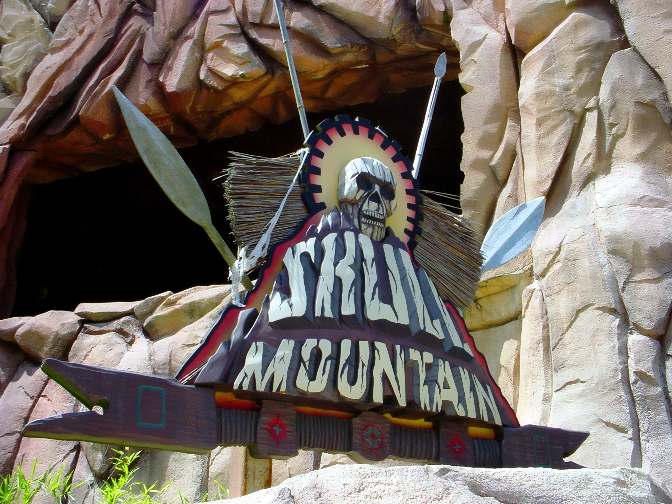 Skull Mountain ride entrance sign carved into rock archway, Skull Mountain, July 2001