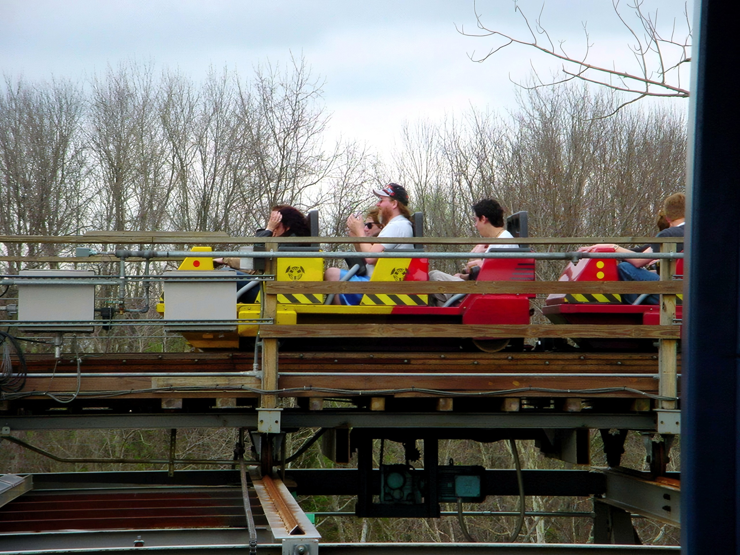 Riders on a Son of Beast train crossing the trestle at Kings Island, April 2002