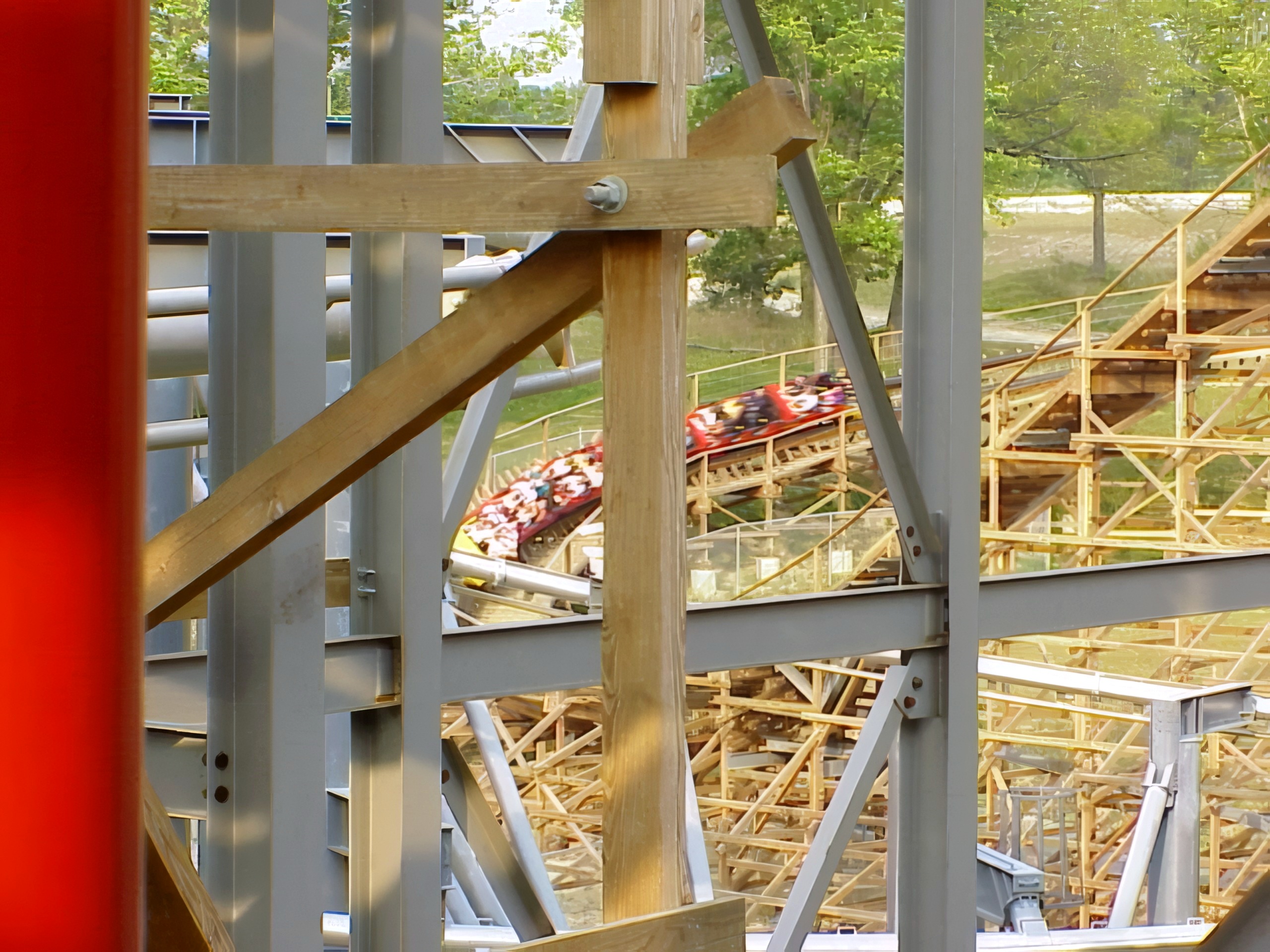 A Son of Beast train passing the steel-and-wood supports at Kings Island, August 2000