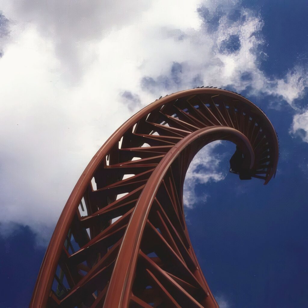 The twisted rear spike of Superman: Ultimate Escape, later Steel Venom, curling into the clouds at Geauga Lake