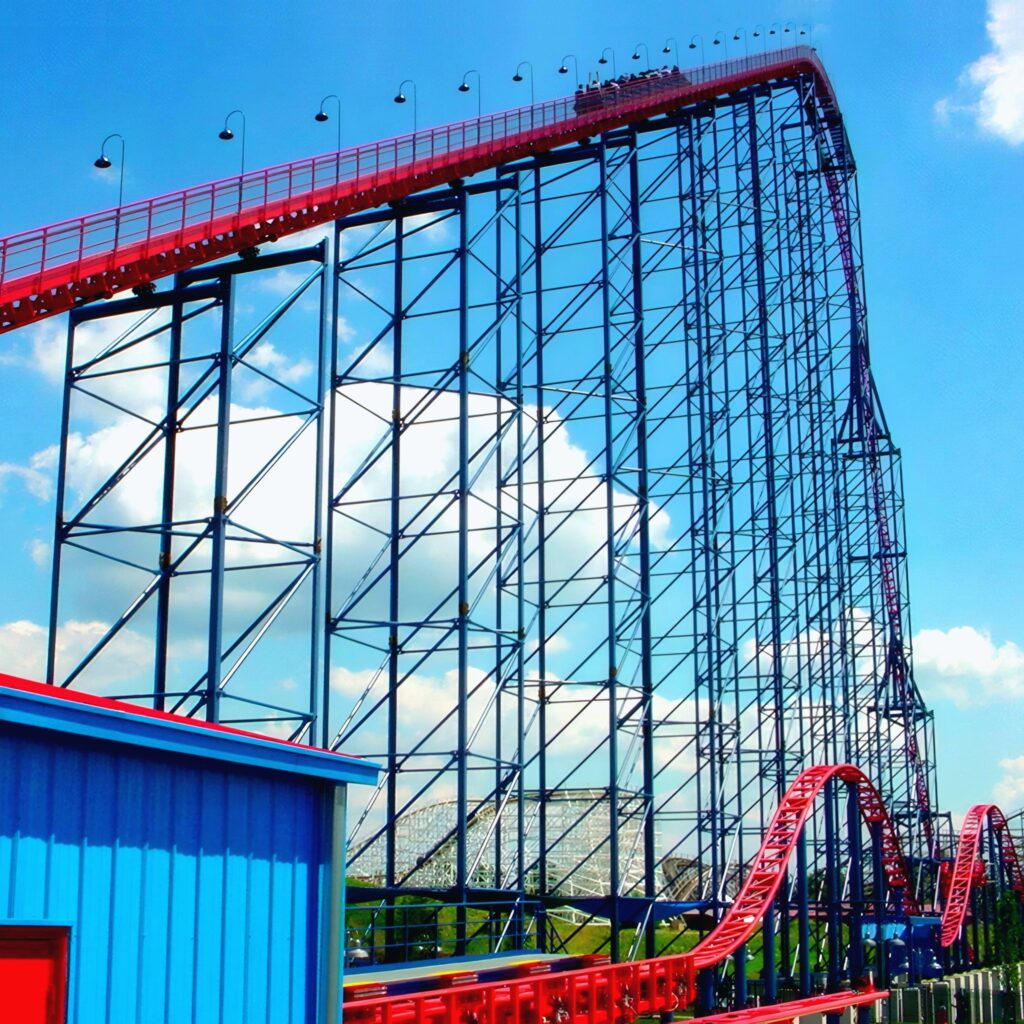 Superman: Ride of Steel at Six Flags America: a train cresting the 200-foot lift hill above the blue lattice
