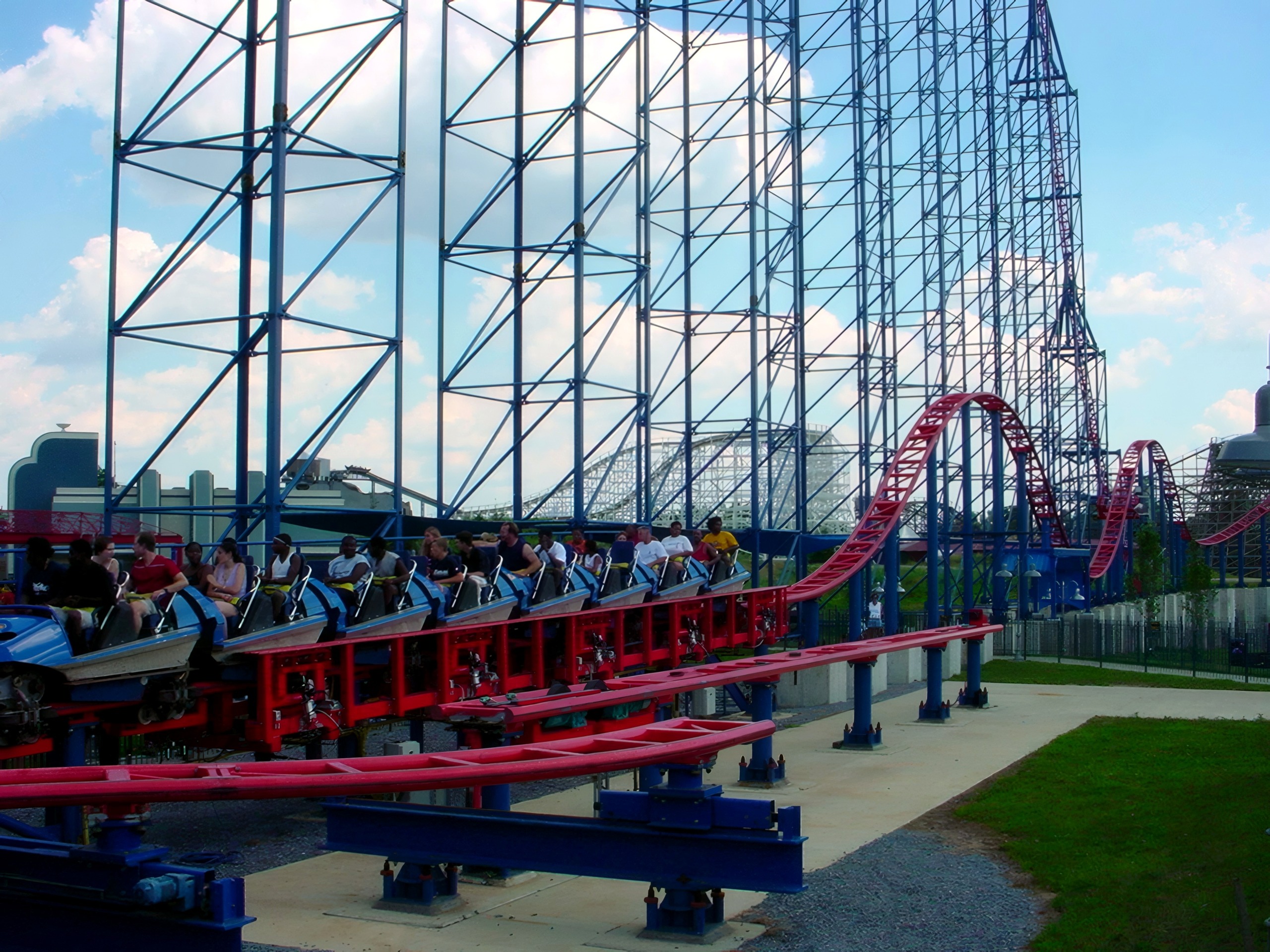A Superman: Ride of Steel train full of riders leaving the station at Six Flags America, July 2001