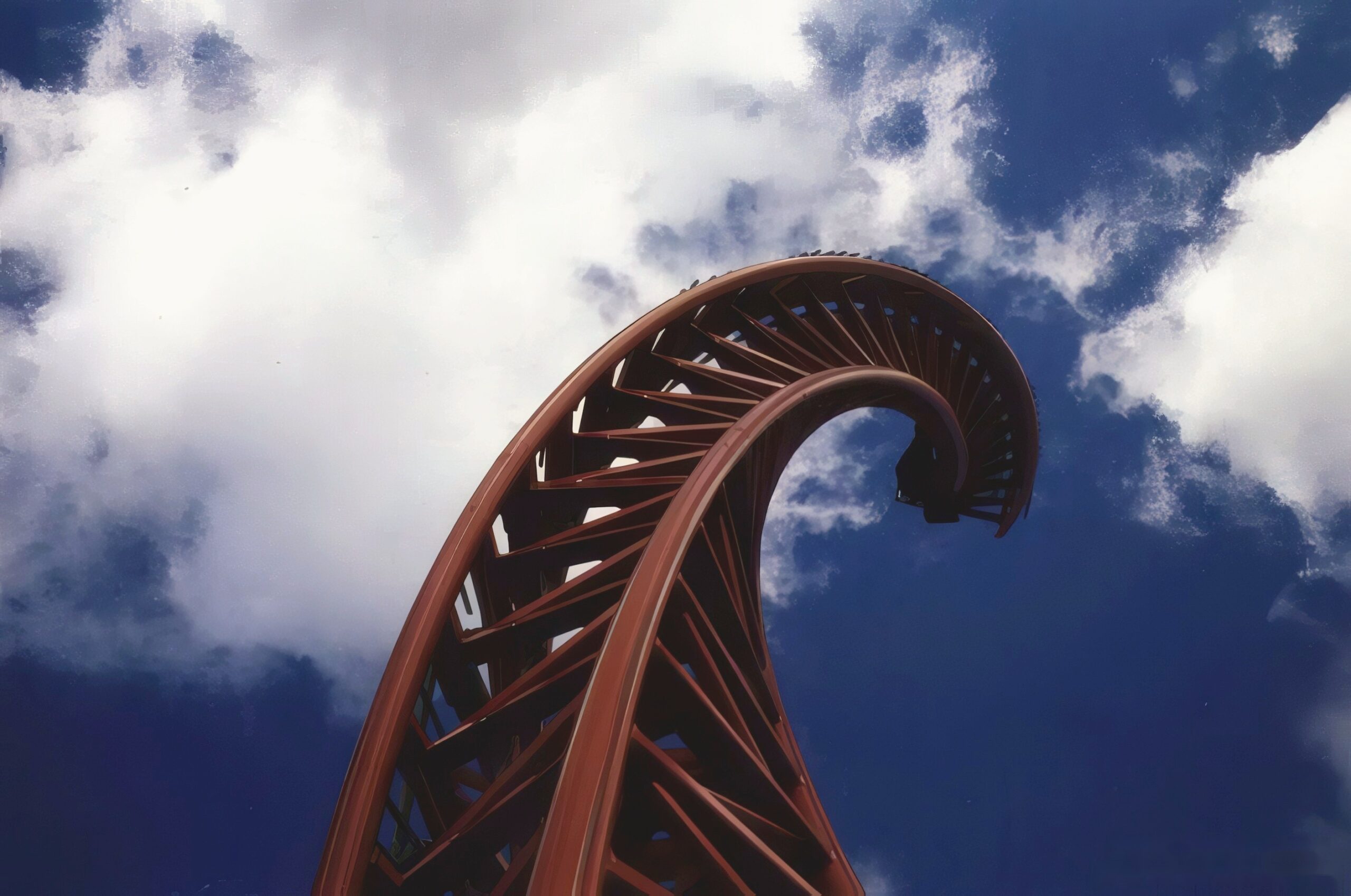 The twisted rear spike of Superman: Ultimate Escape, later Steel Venom, curling into the clouds at Geauga Lake, May 2000