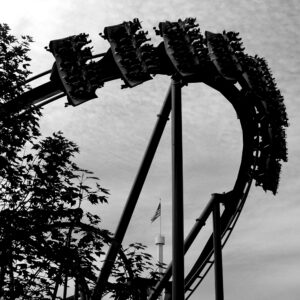 A Superman: Ultimate Flight train, riders prone, arcing through the loop at Six Flags Great America, in black and white