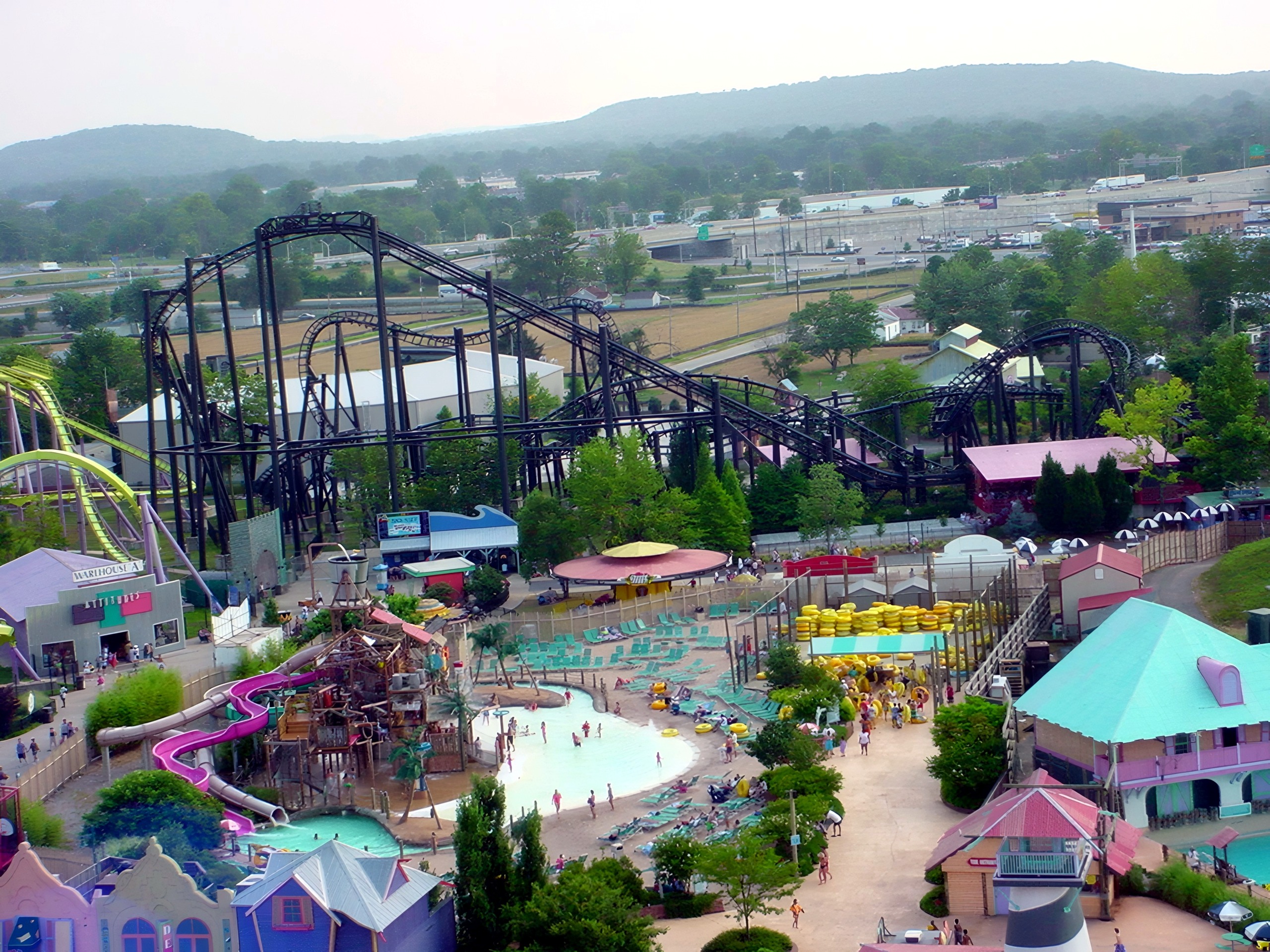Aerial view of black steel coaster above water park area, T2, July 2002