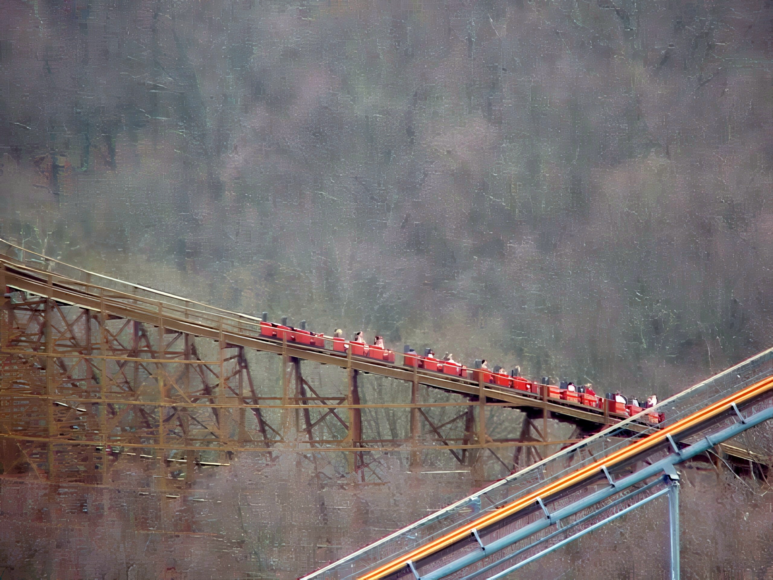 A Beast train descending the long trestle through the woods, seen from the Eiffel Tower at Kings Island, April 2001