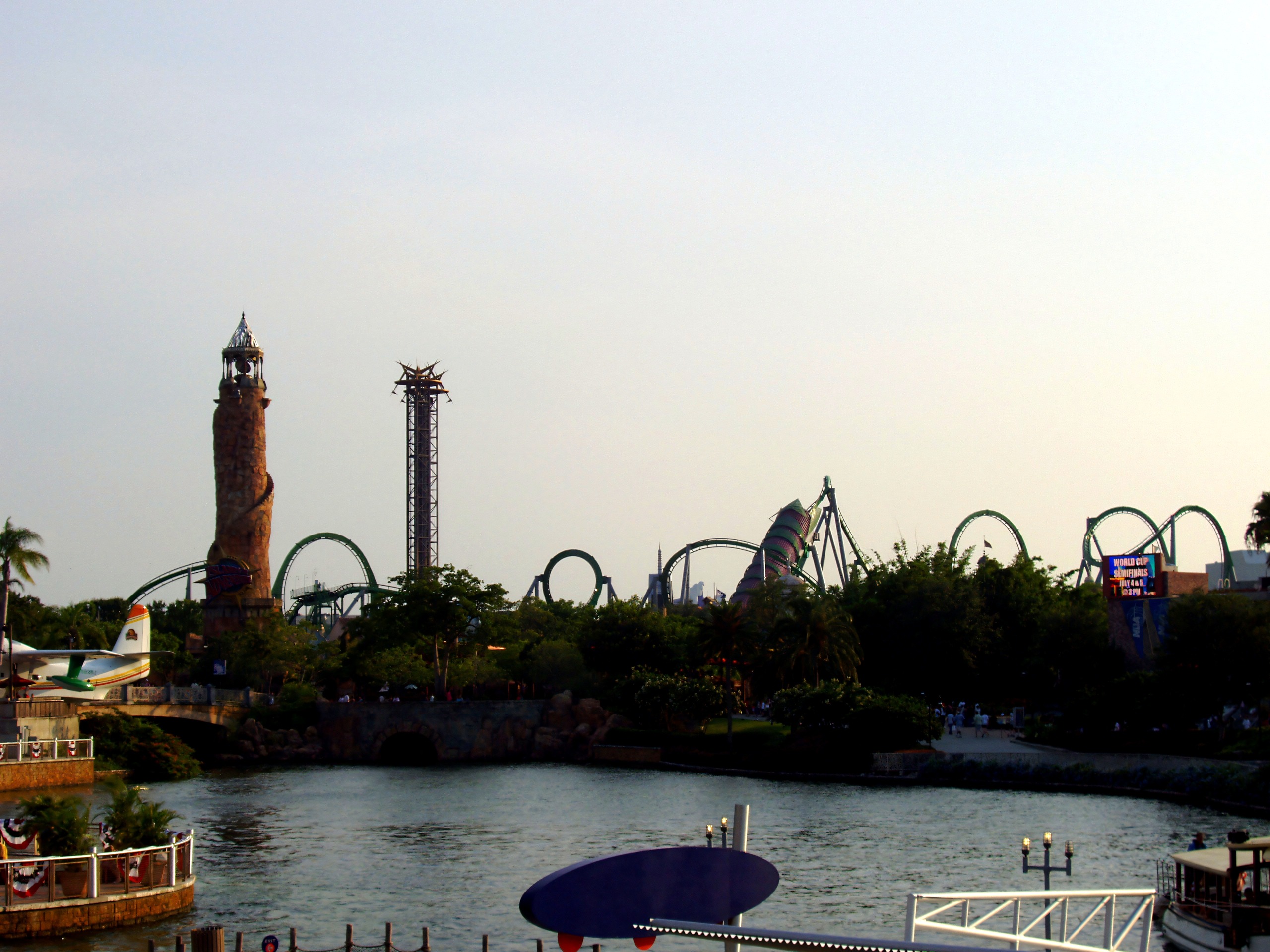 Islands of Adventure skyline from across the lagoon with the lighthouse and the Hulk's green loops, The Incredible Hulk Coaster, June 2006