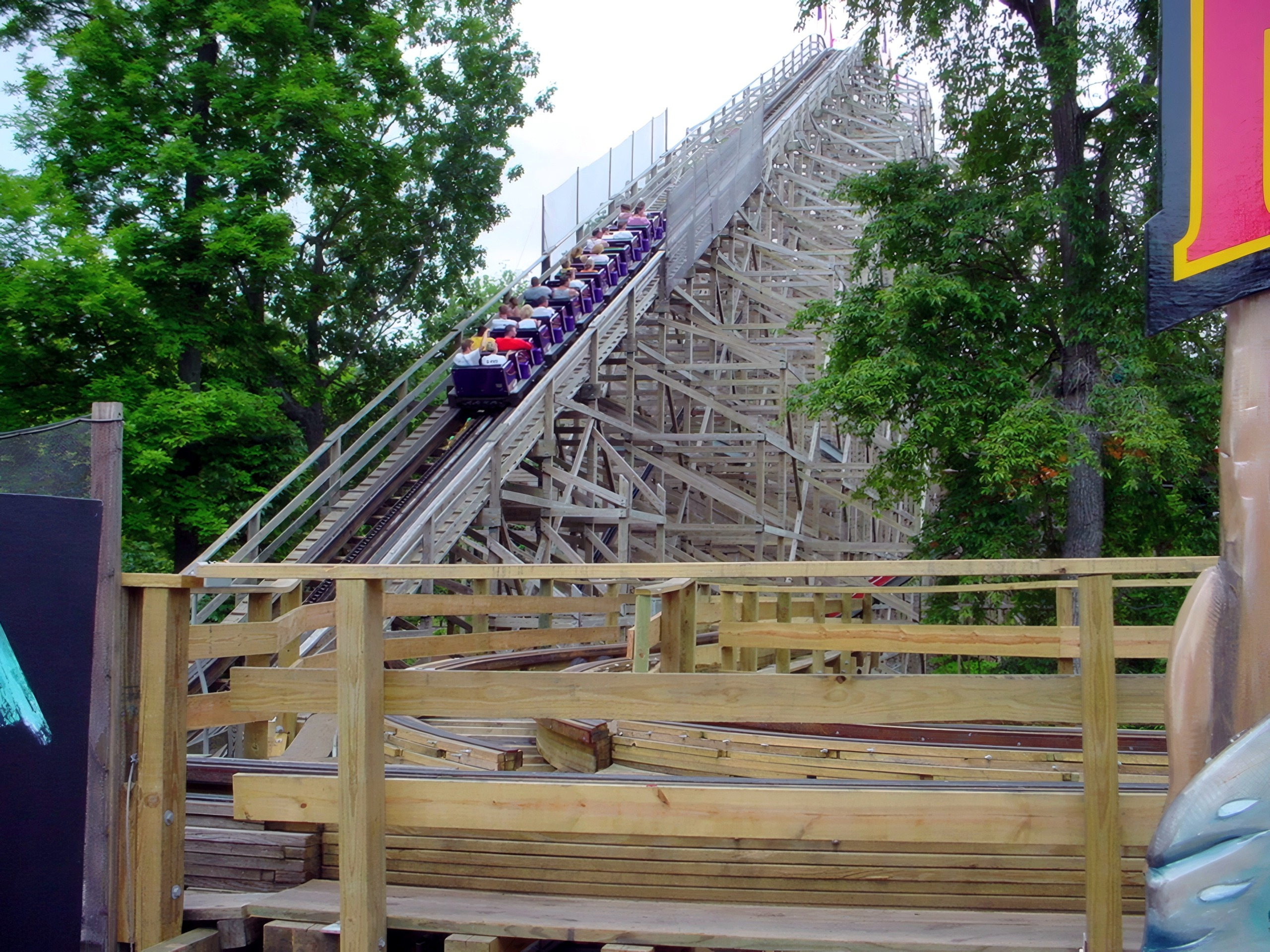 A Legend train climbing the lift hill among the trees, July 2002