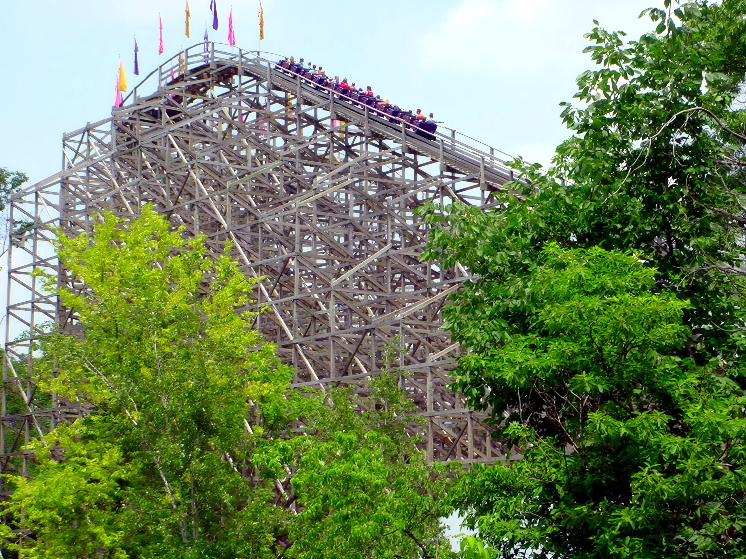 A Legend train cresting the lift seen through the trees, July 2002