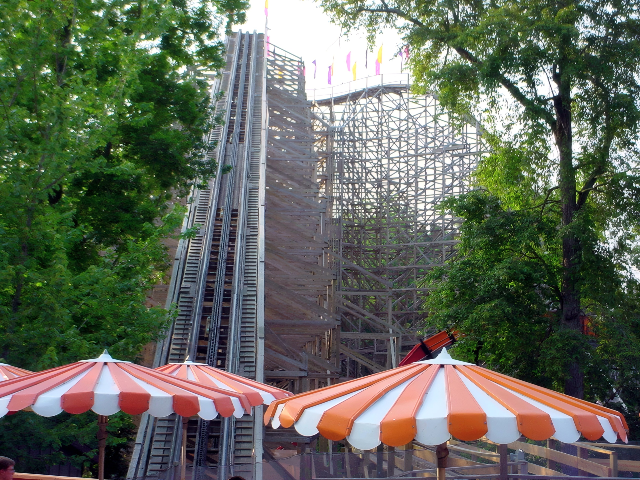 The Legend's lift hill above the striped umbrellas of the picnic area, July 2002