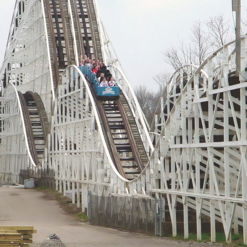 The Racer at Kings Island: a blue train near the top of the twin-track lift hill