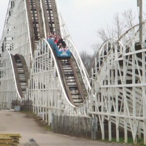 The Racer at Kings Island: a blue train near the top of the twin-track lift hill
