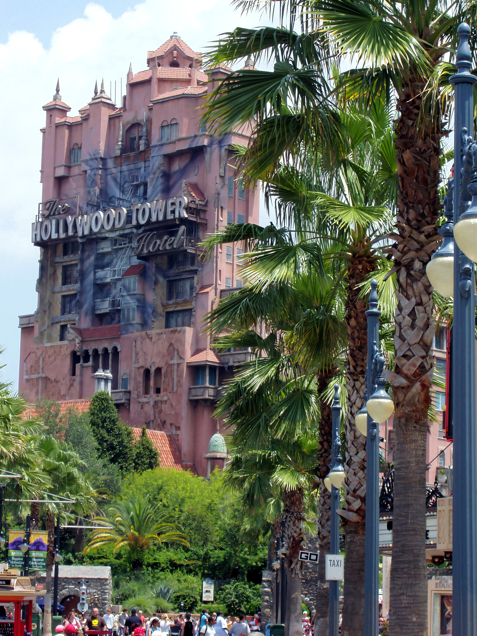 The Hollywood Tower Hotel of The Twilight Zone Tower of Terror behind palm trees and lampposts at Disney's Hollywood Studios, June 2006