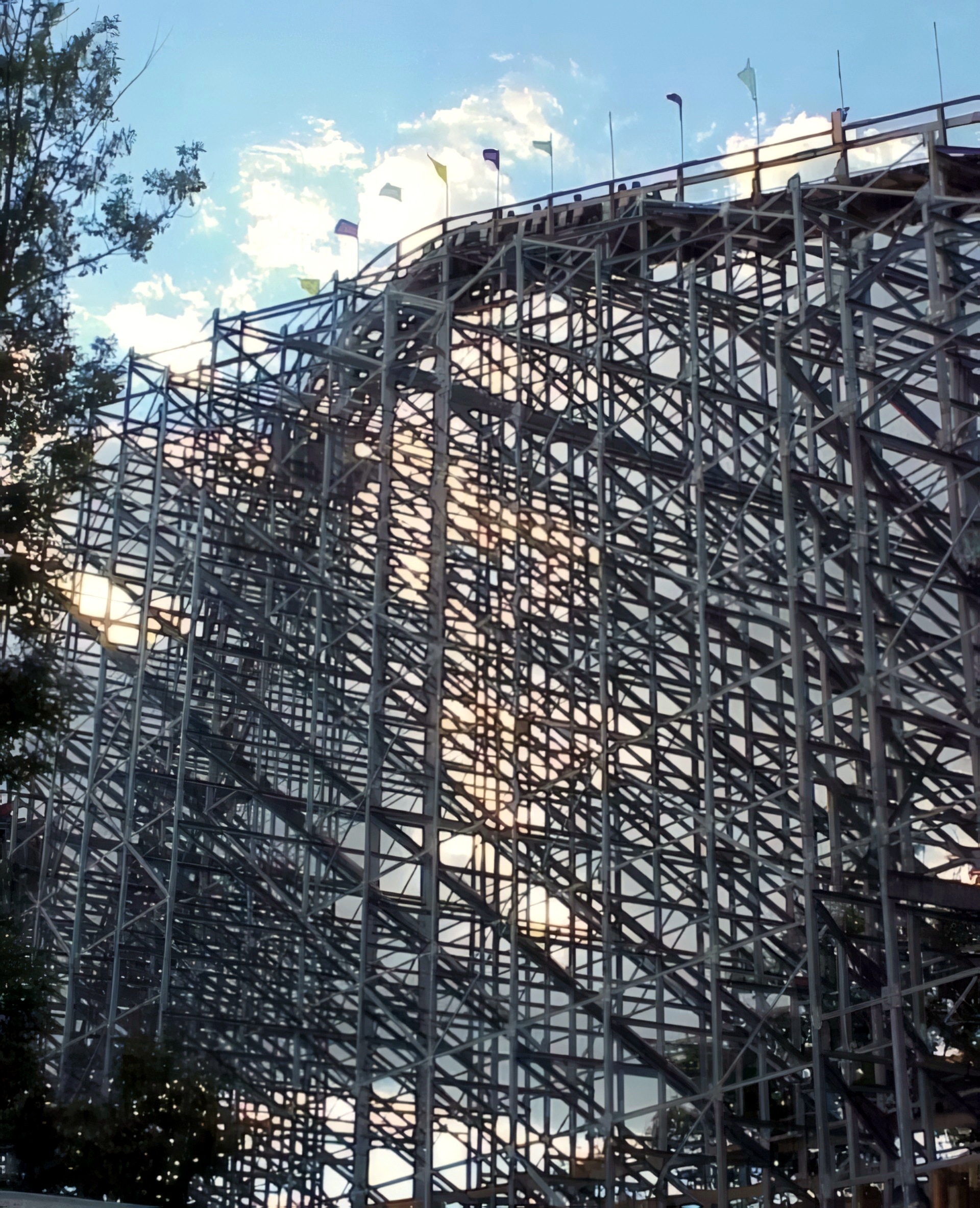 The Villain's hill crest and flags under the clouds at Geauga Lake, May 2000