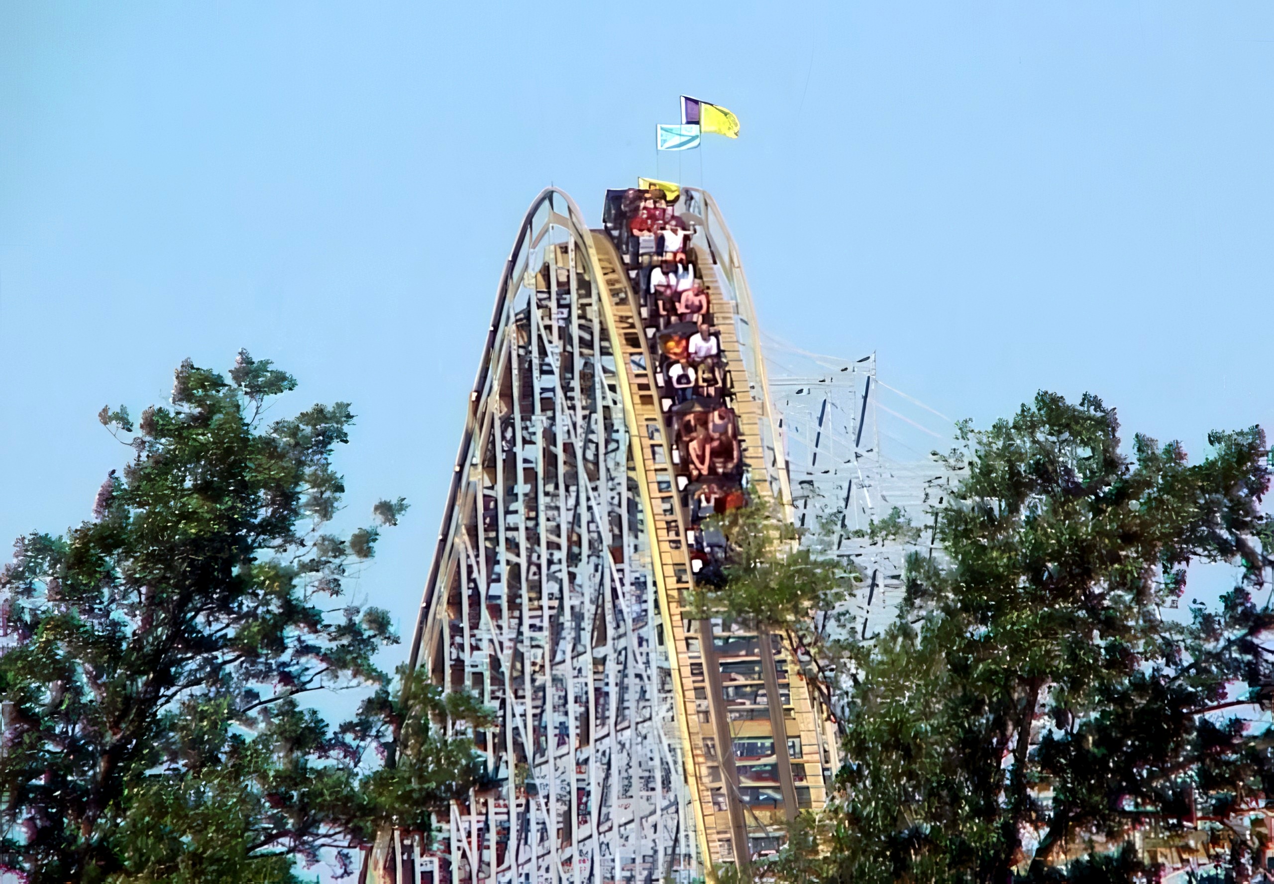 A Villain train cresting the lift hill under the flags at Geauga Lake, May 2000