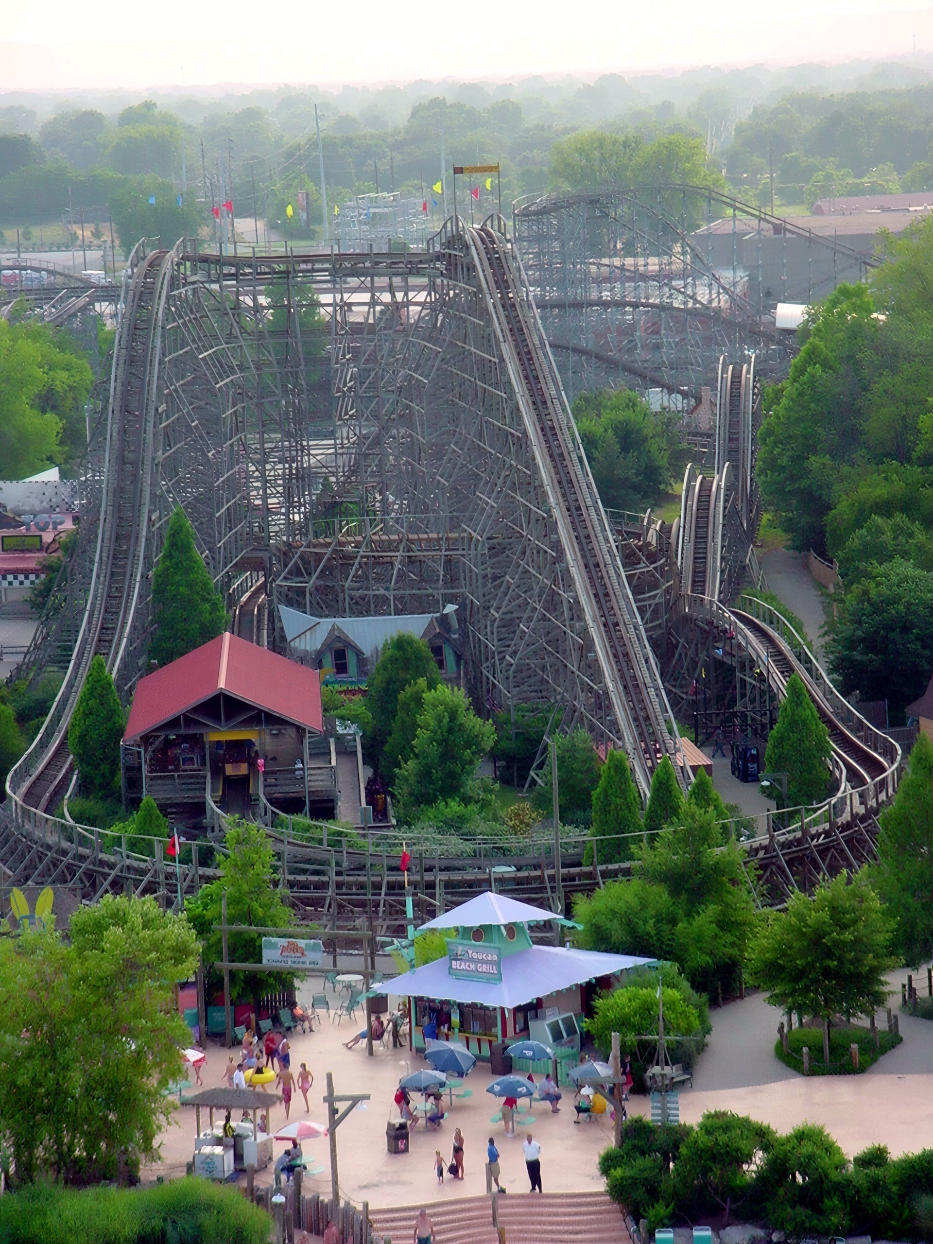Thunder Run's wooden hills and station over the Toucan Beach Grill plaza at Six Flags Kentucky Kingdom, July 2002