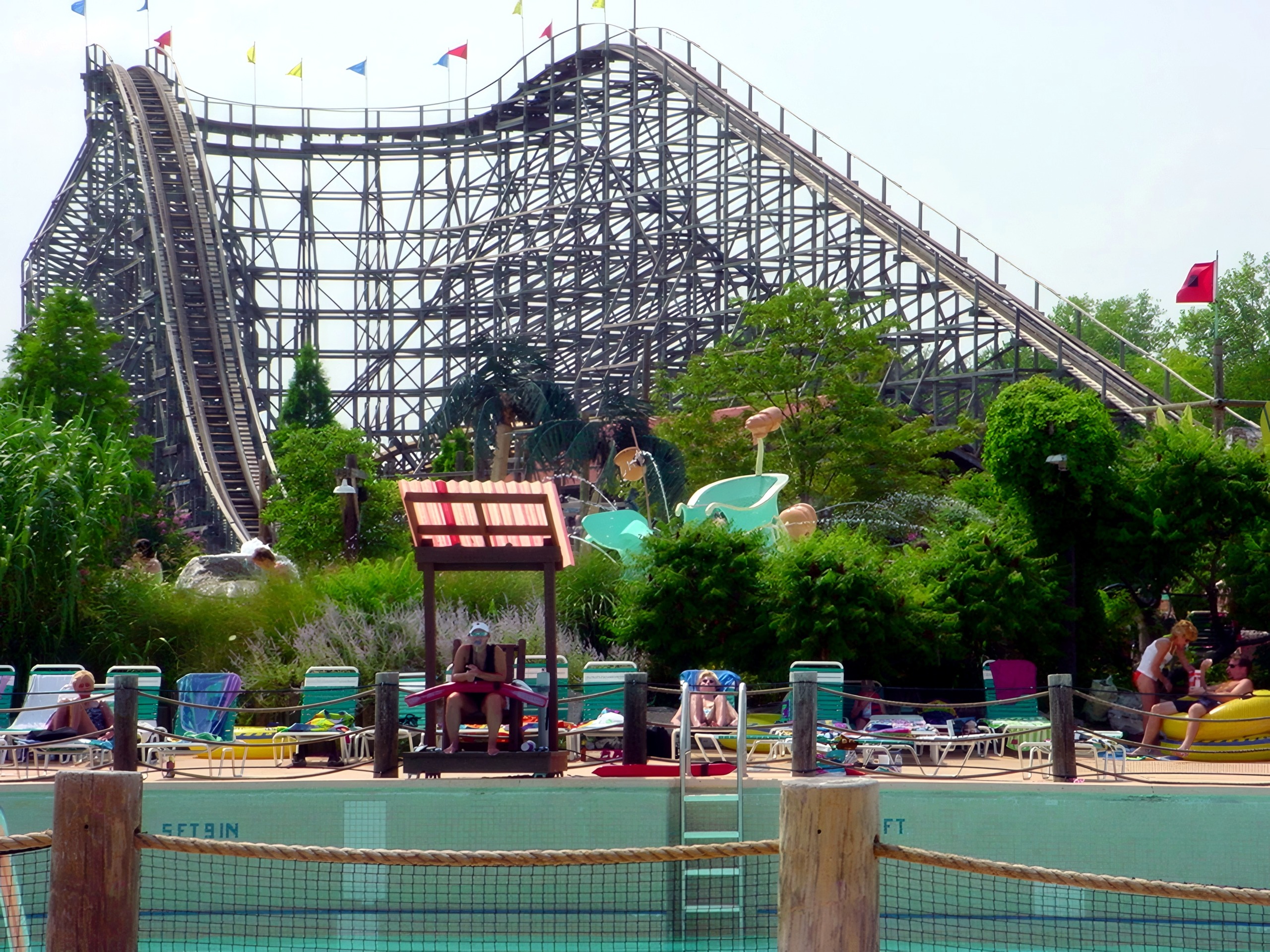 Thunder Run's wooden hills rising behind a poolside deck at Six Flags Kentucky Kingdom, July 2002