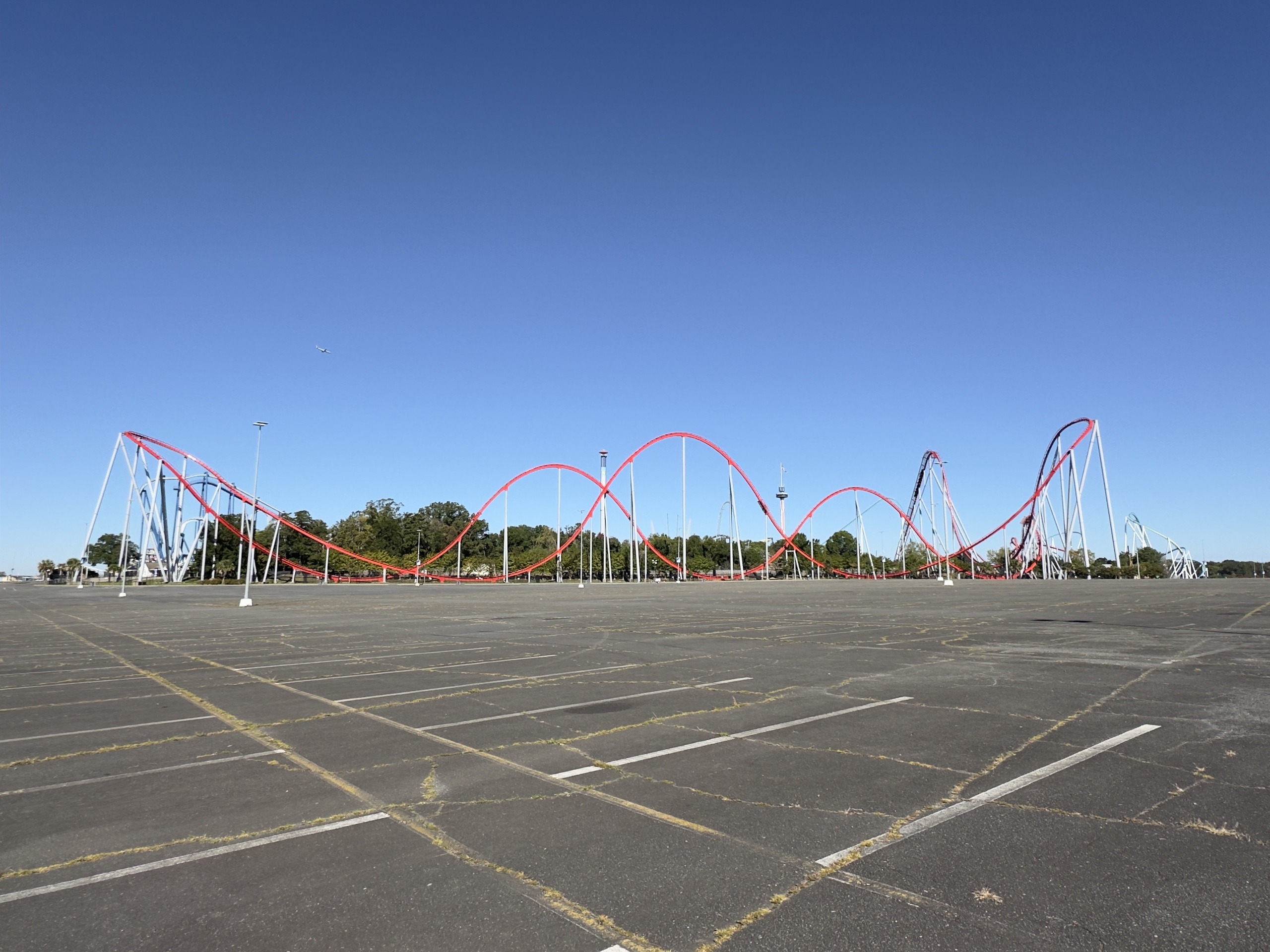 Thunder Striker's red hills stretching across the parking lot, Carowinds, October 2024