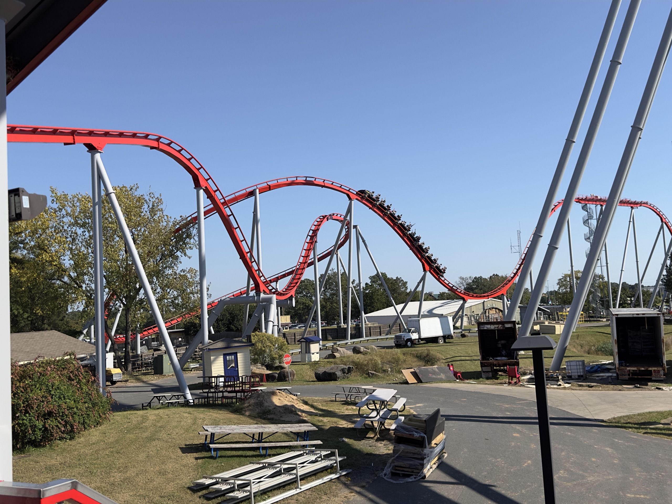 Thunder Striker's red hills and a train from the station area, Carowinds, October 2024