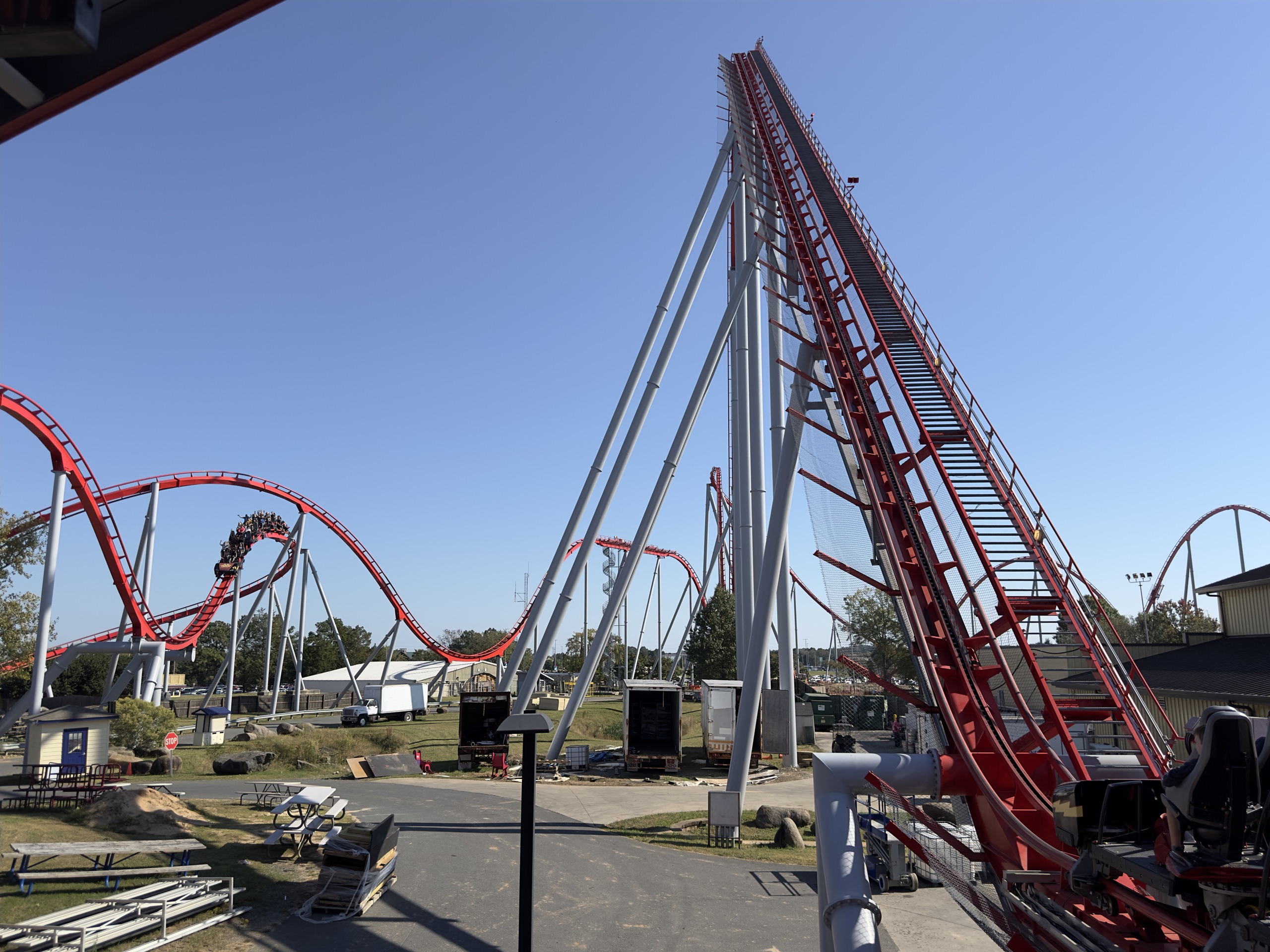 Thunder Striker's lift hill rising from the station with a train on the hills, Carowinds, October 2024