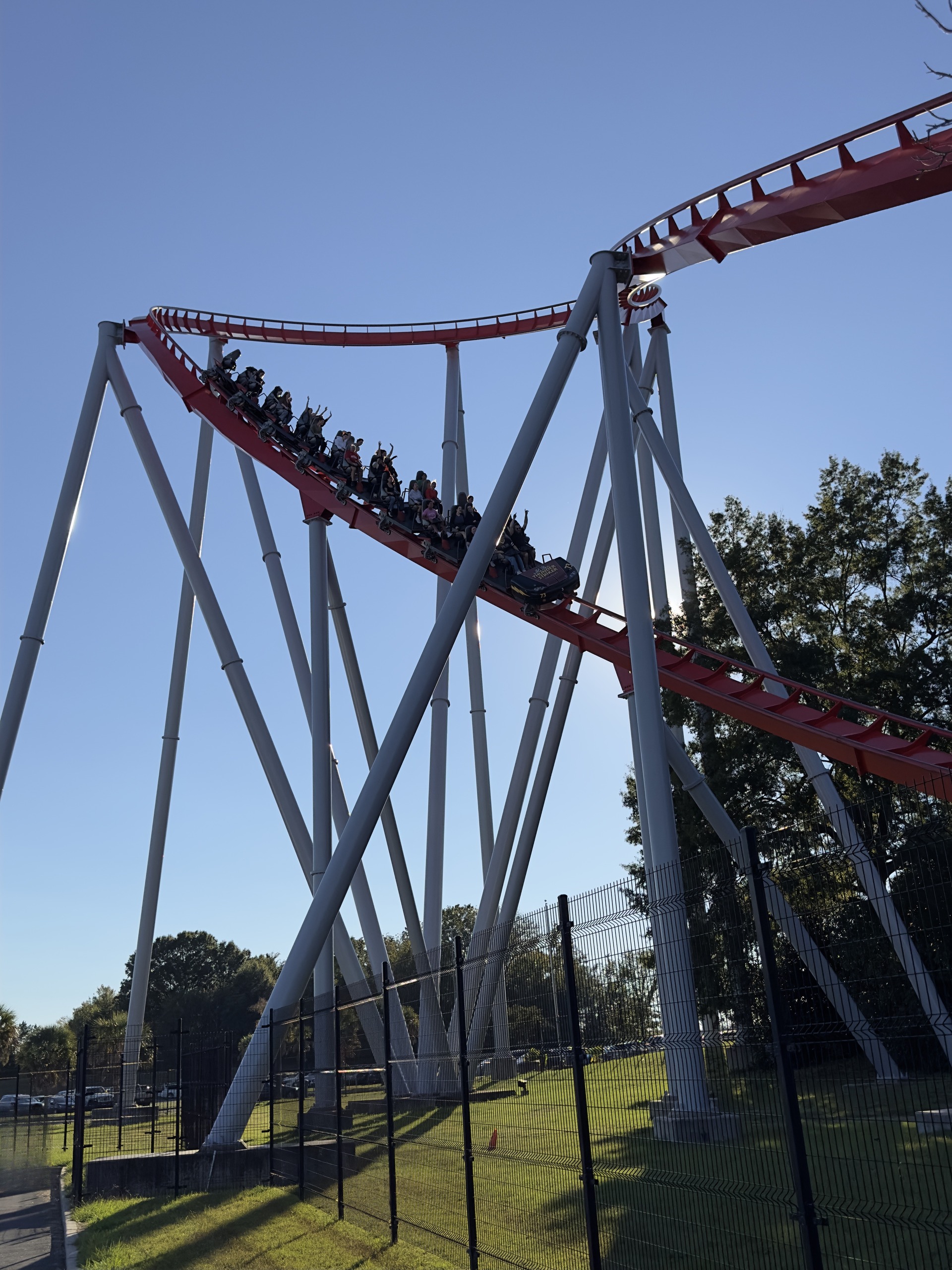 Thunder Striker riders with their hands up on a red hill, Carowinds, October 2024