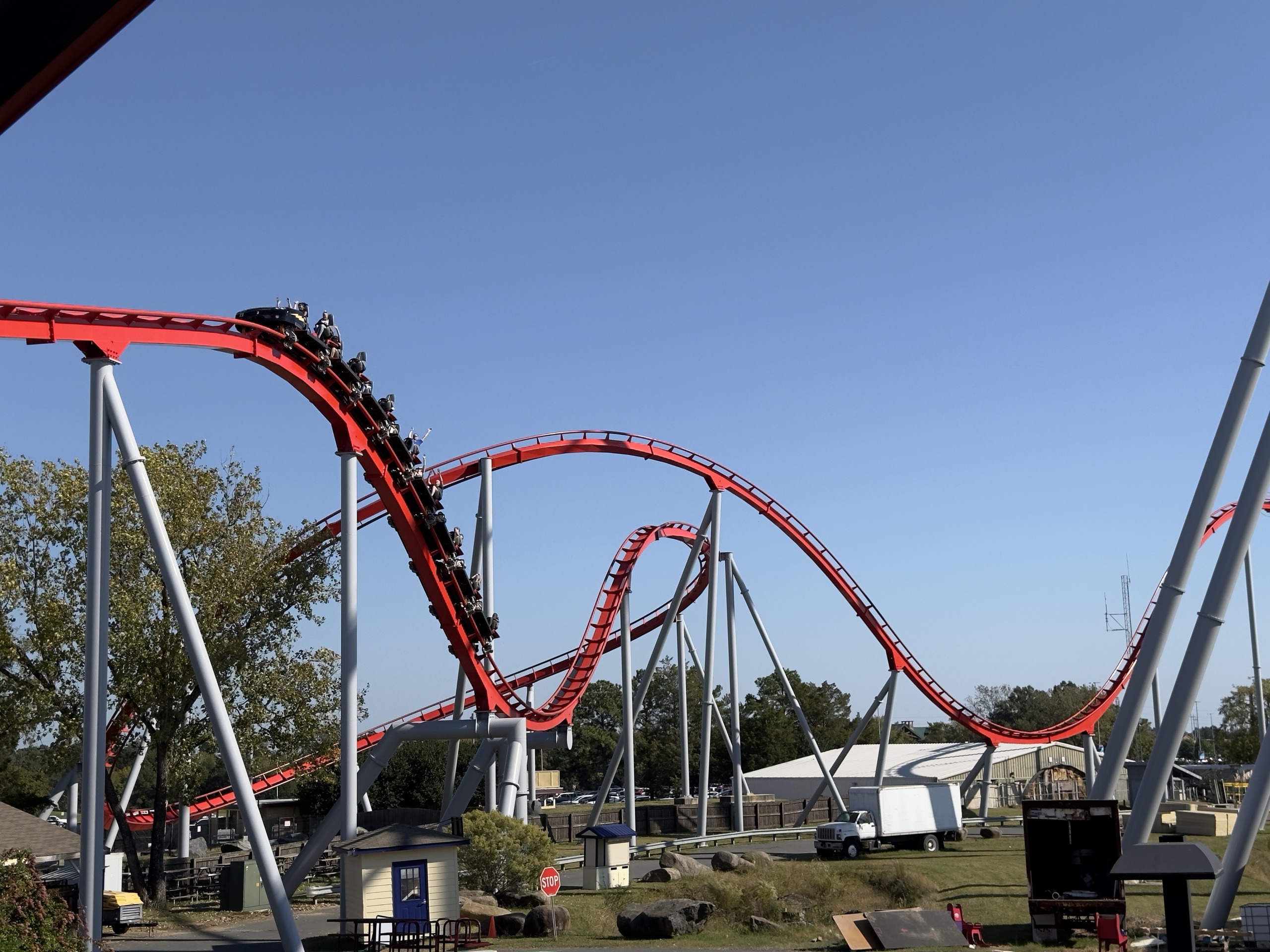 A Thunder Striker train diving down a red hill, Carowinds, October 2024