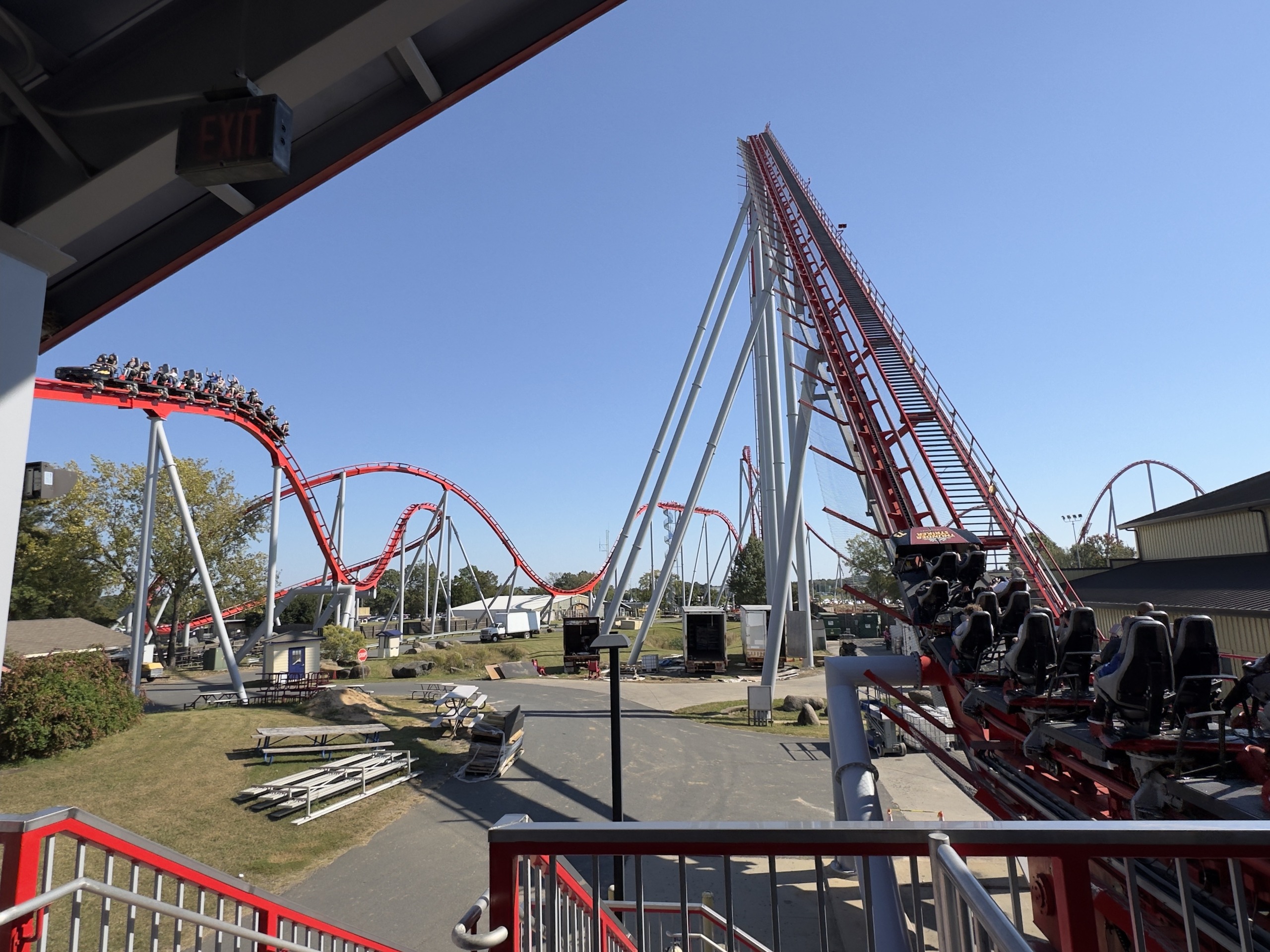 A Thunder Striker train heading out of the station toward the lift, Carowinds, October 2024