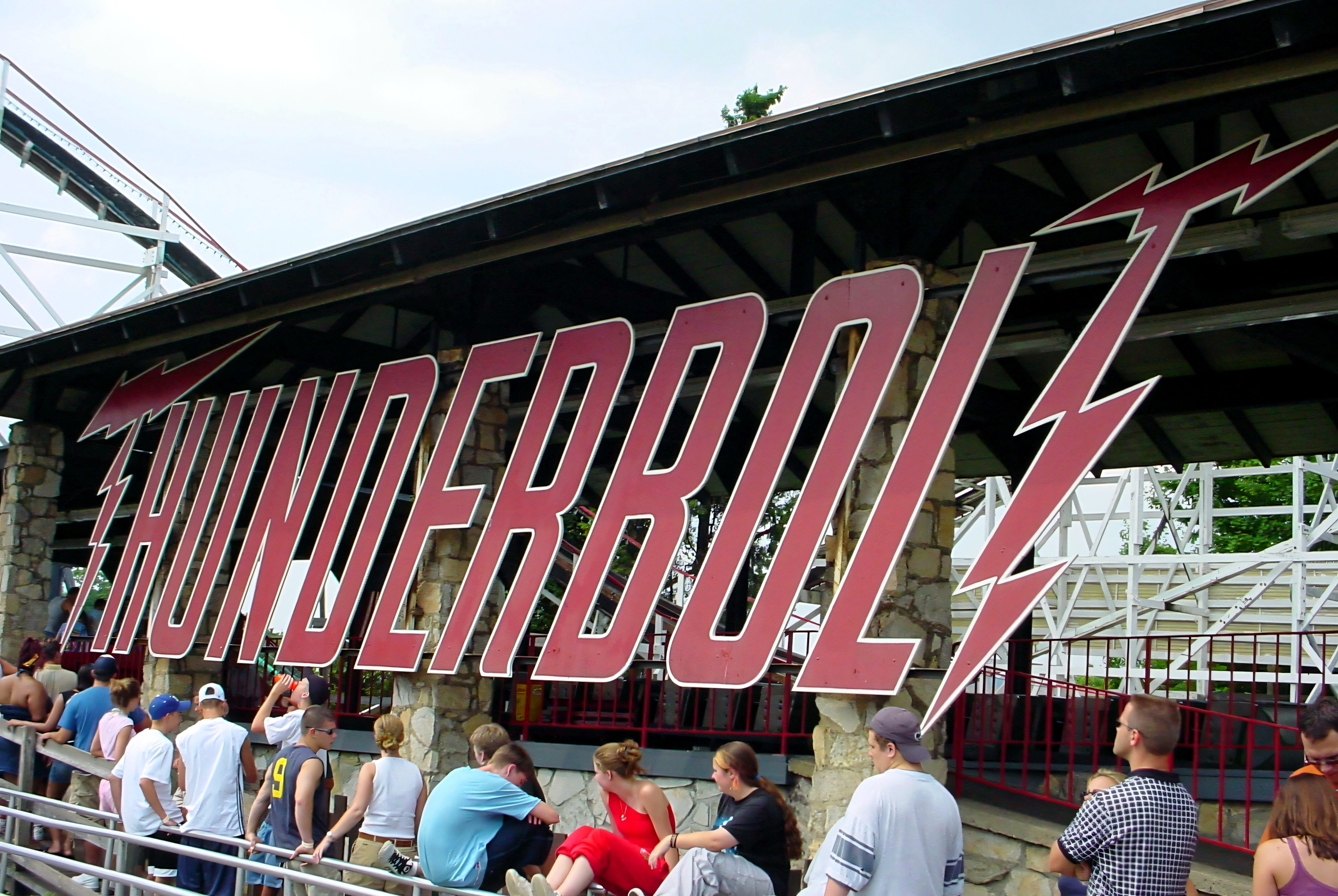 The Thunderbolt entrance sign with riders queuing below, July 2003
