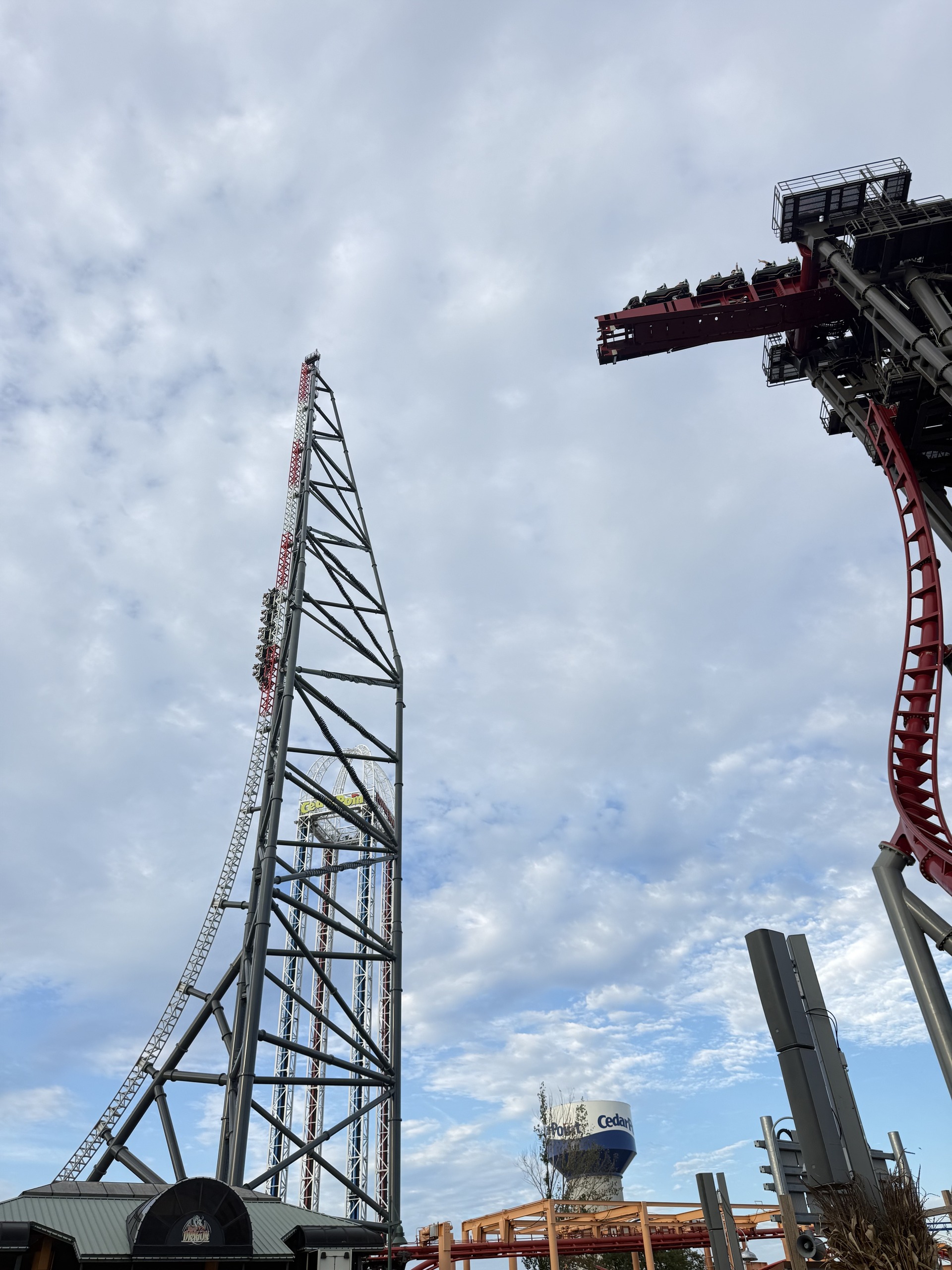 The Top Thrill 2 vertical spike with a train climbing and the Siren's Curse tilt at right