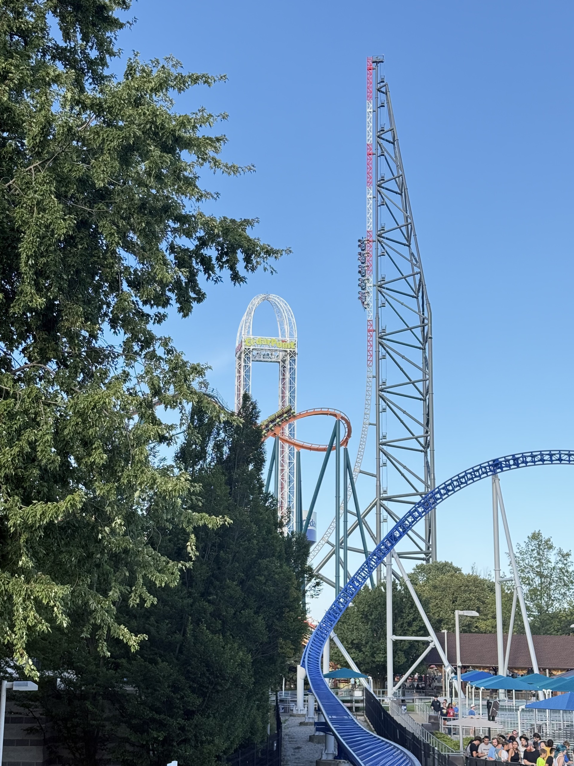 The Top Thrill 2 tower behind the trees with Millennium Force's blue track at right